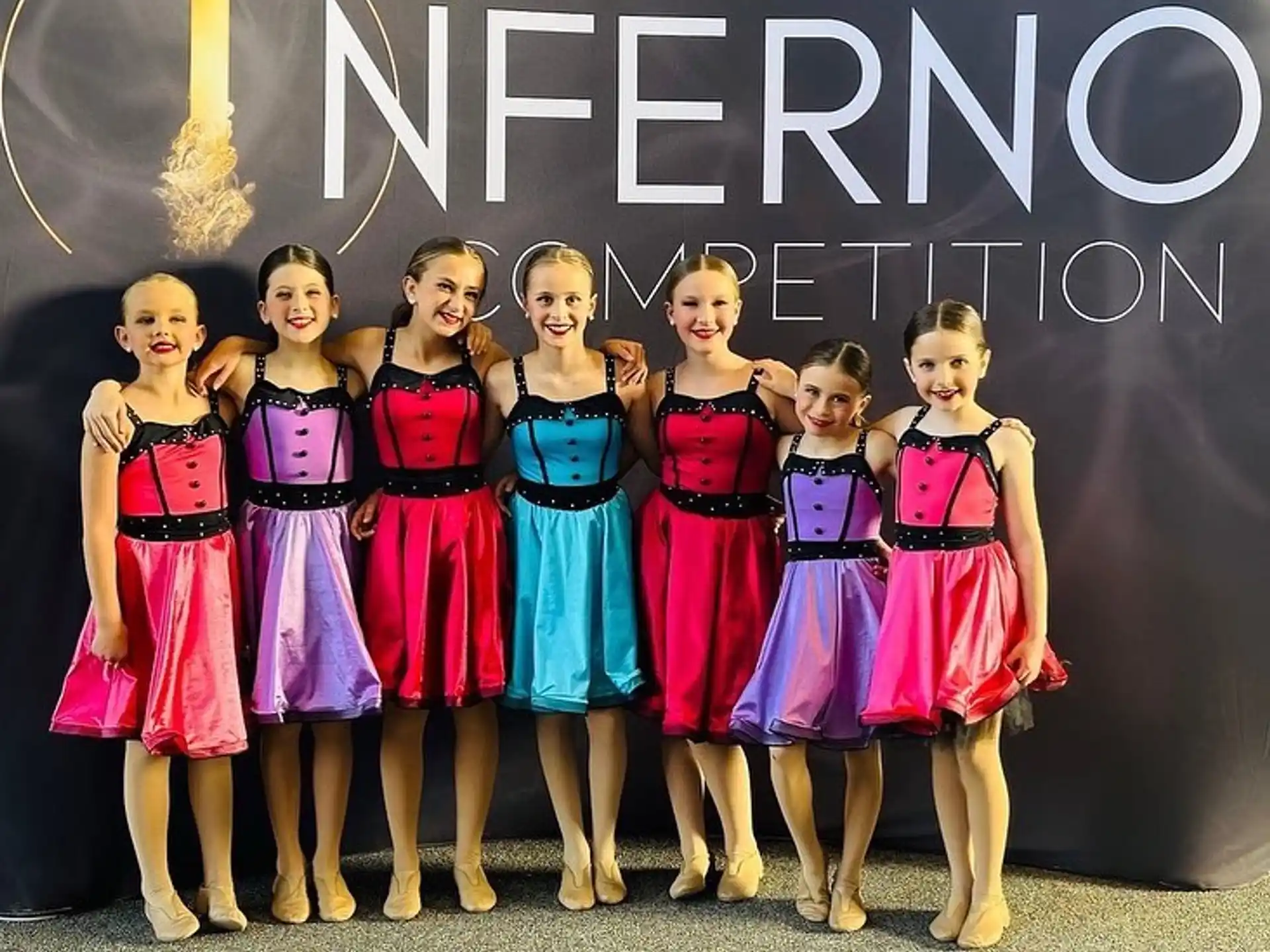 a group of girls in dresses