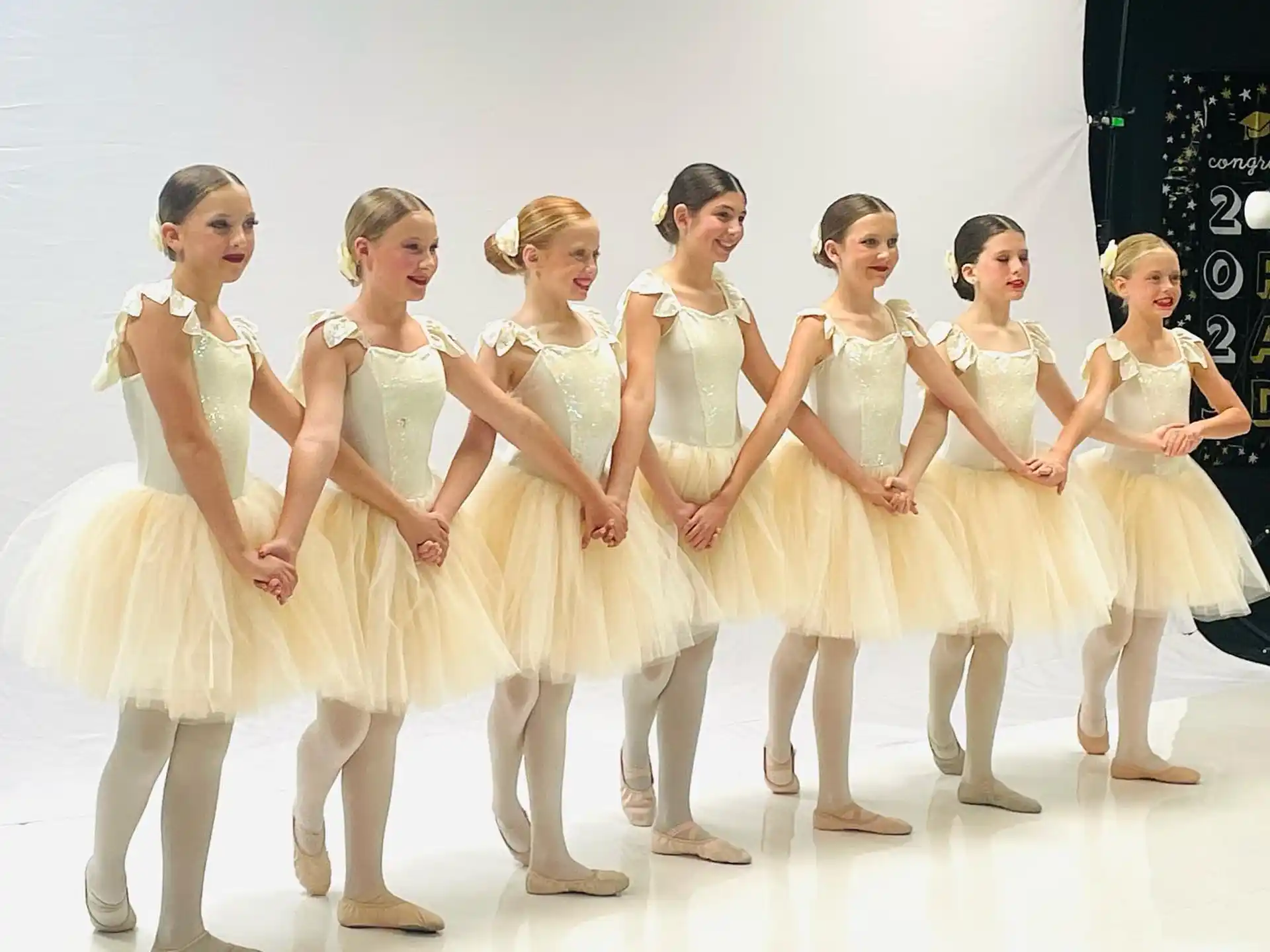 a group of women in white dresses