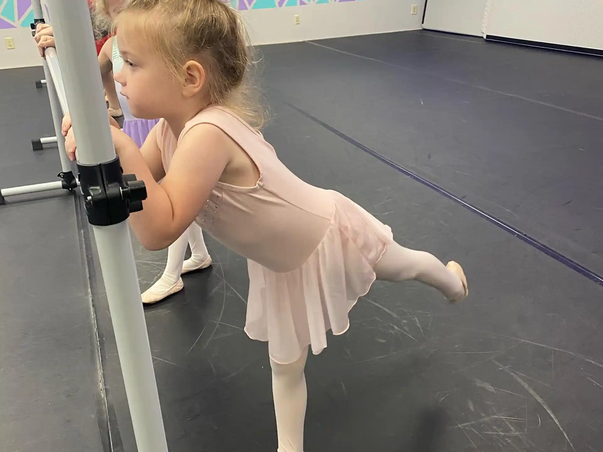 a girl in a dress on a gym