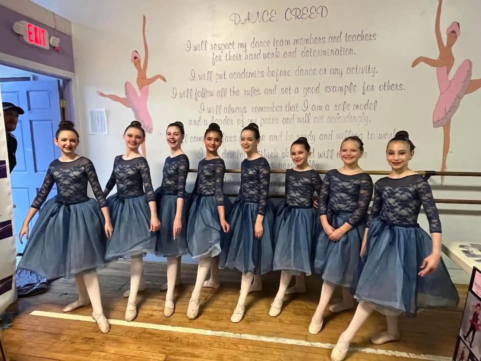 a group of girls in blue dresses