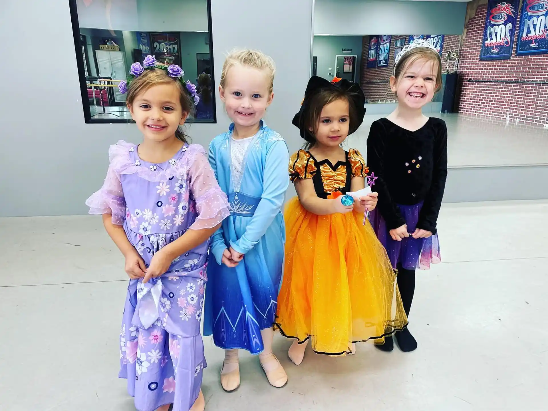 a group of girls in dresses