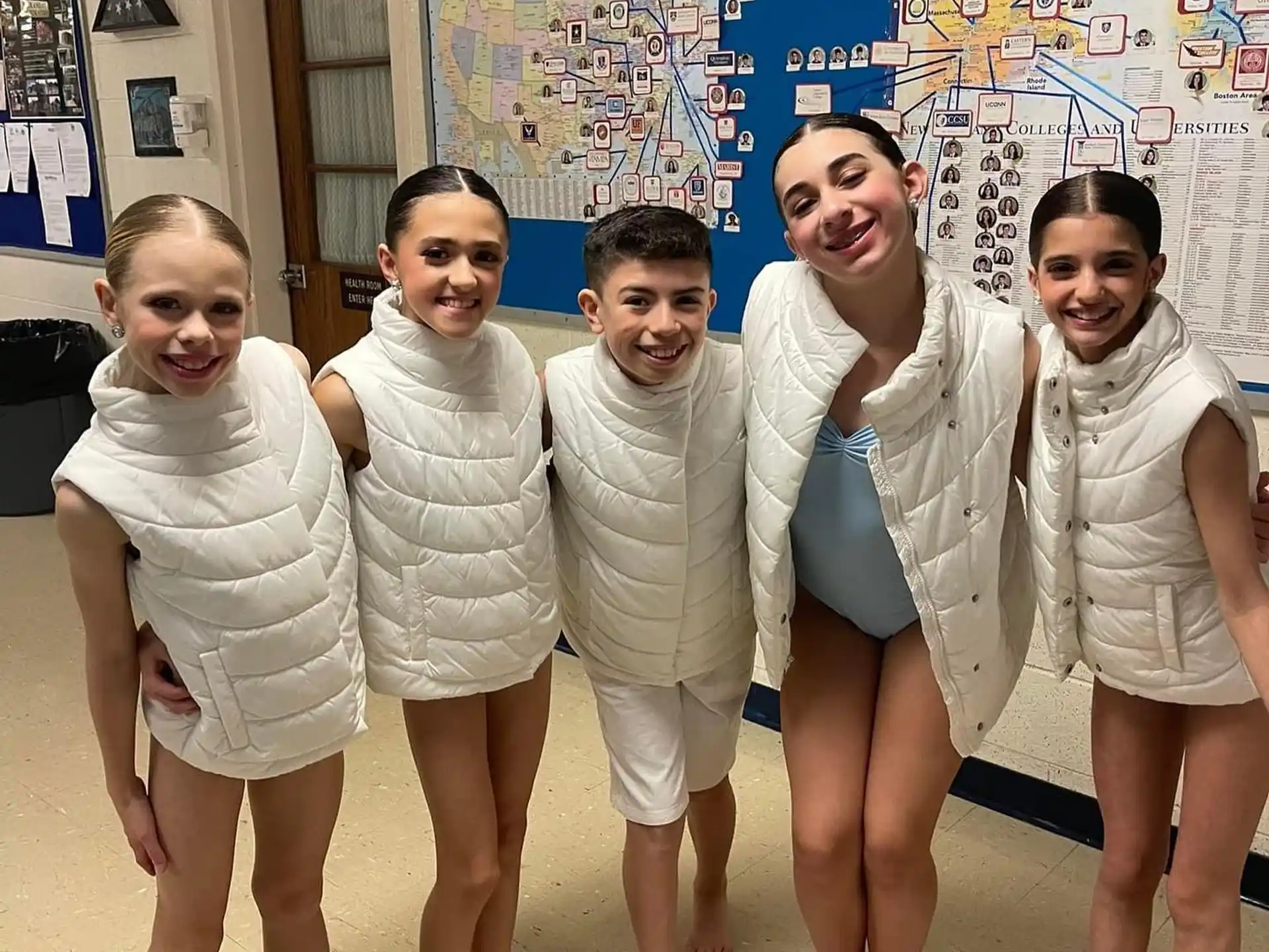 a group of children in white uniforms