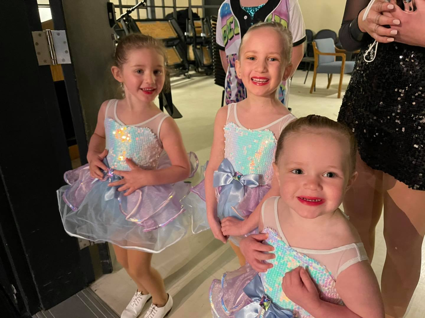 a group of young girls in dresses