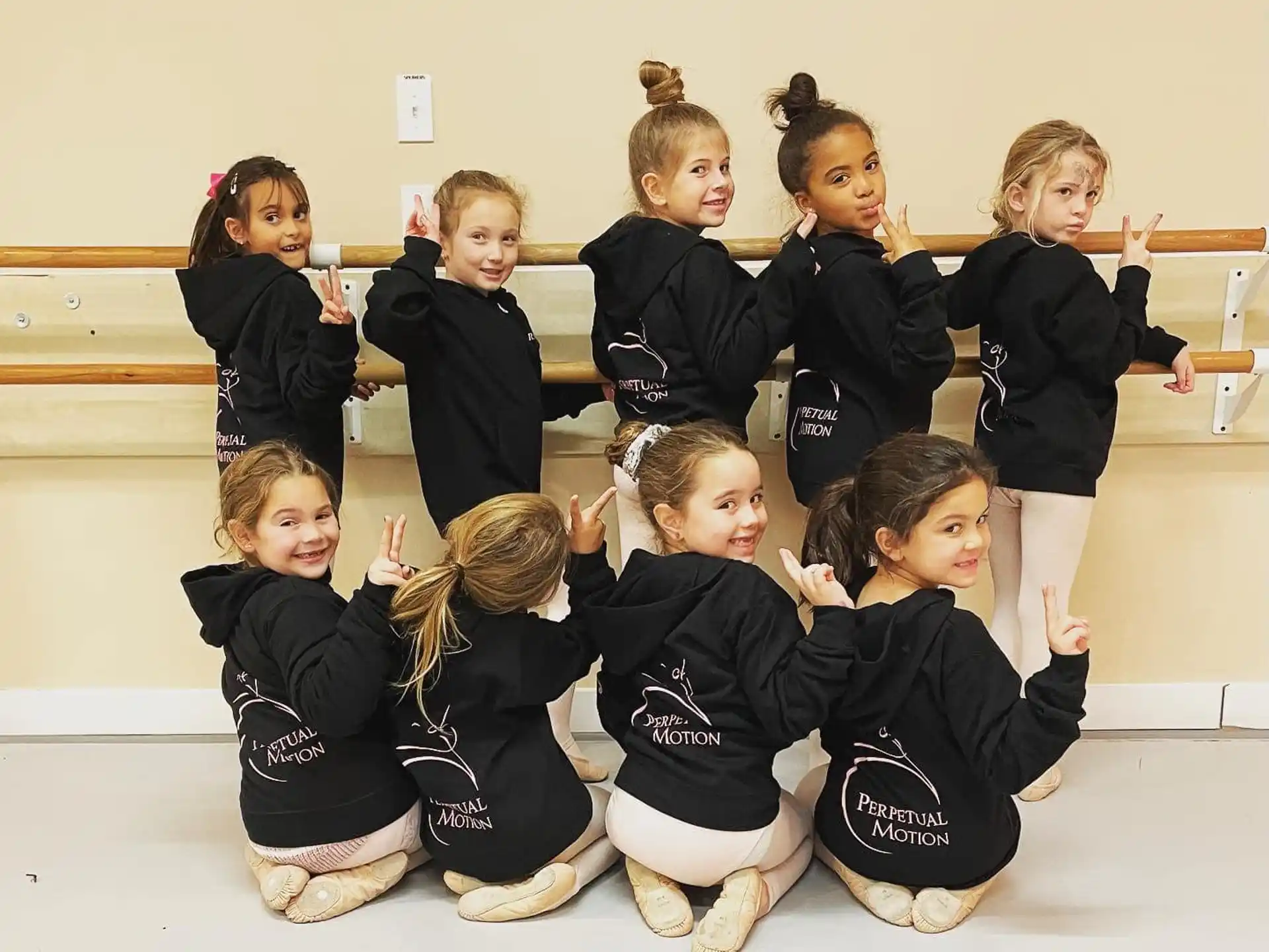 a group of children in black and white uniforms
