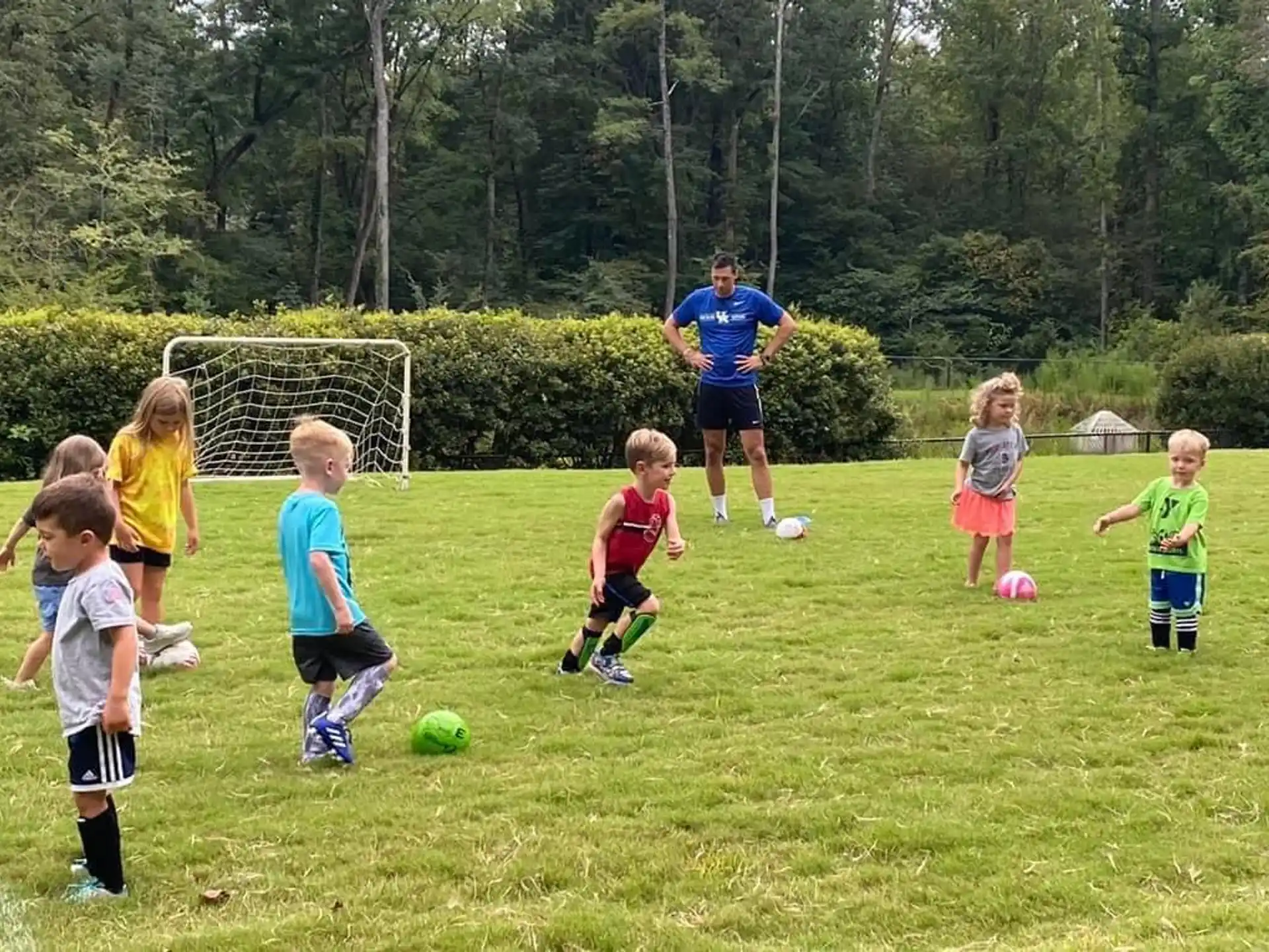 kids playing football in the grass