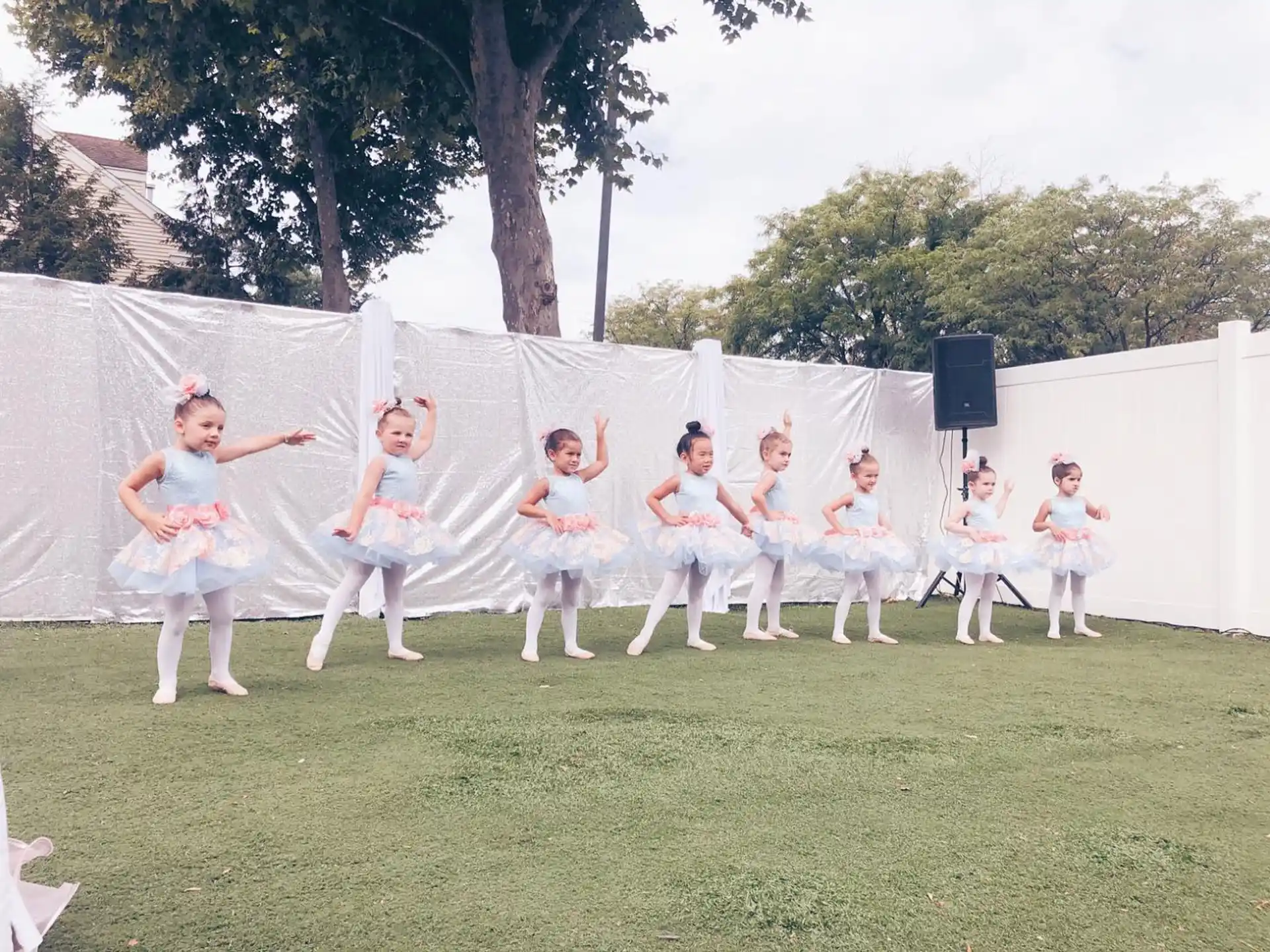 a group of people in white outfits