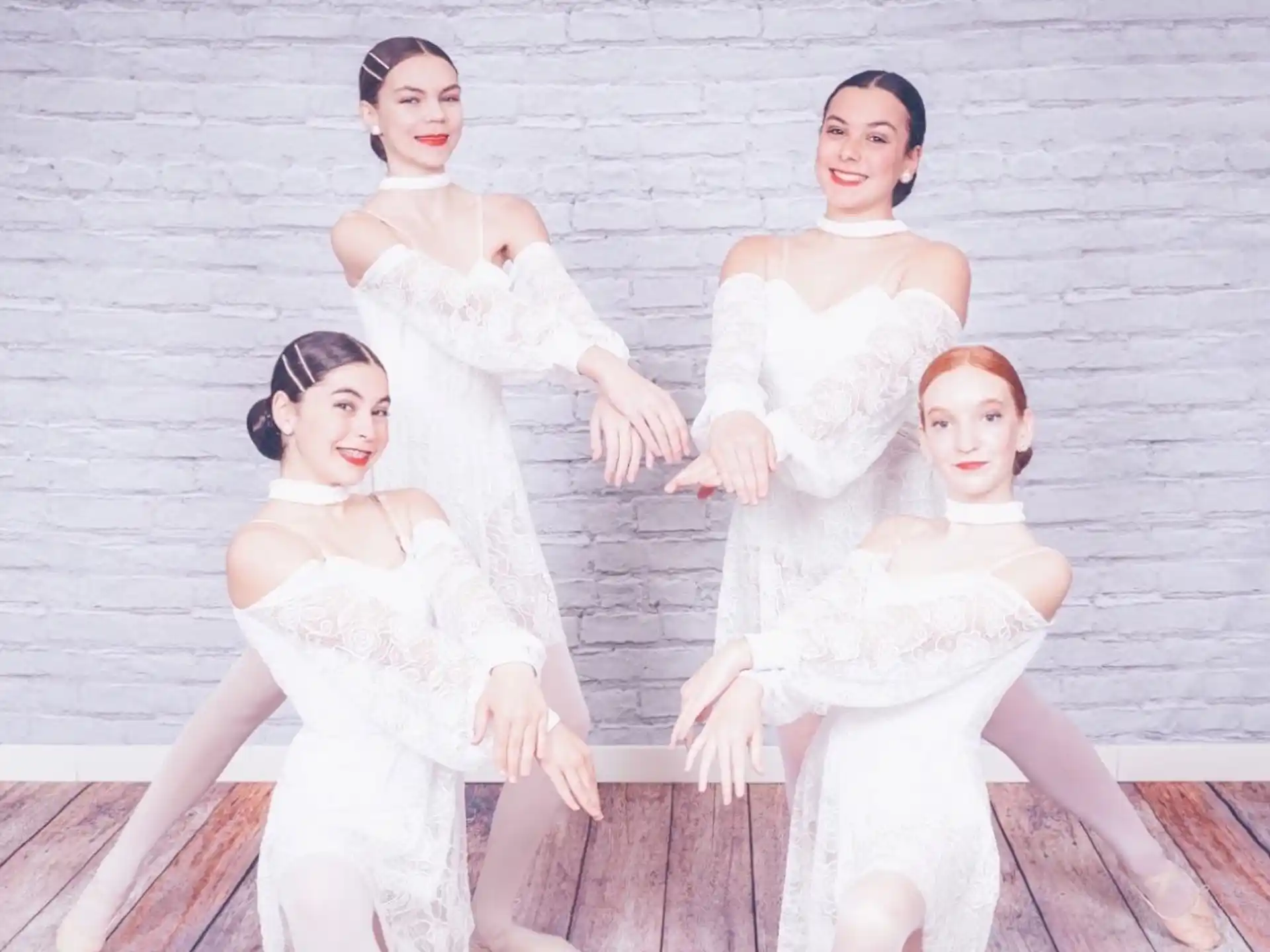 a group of women in white dresses