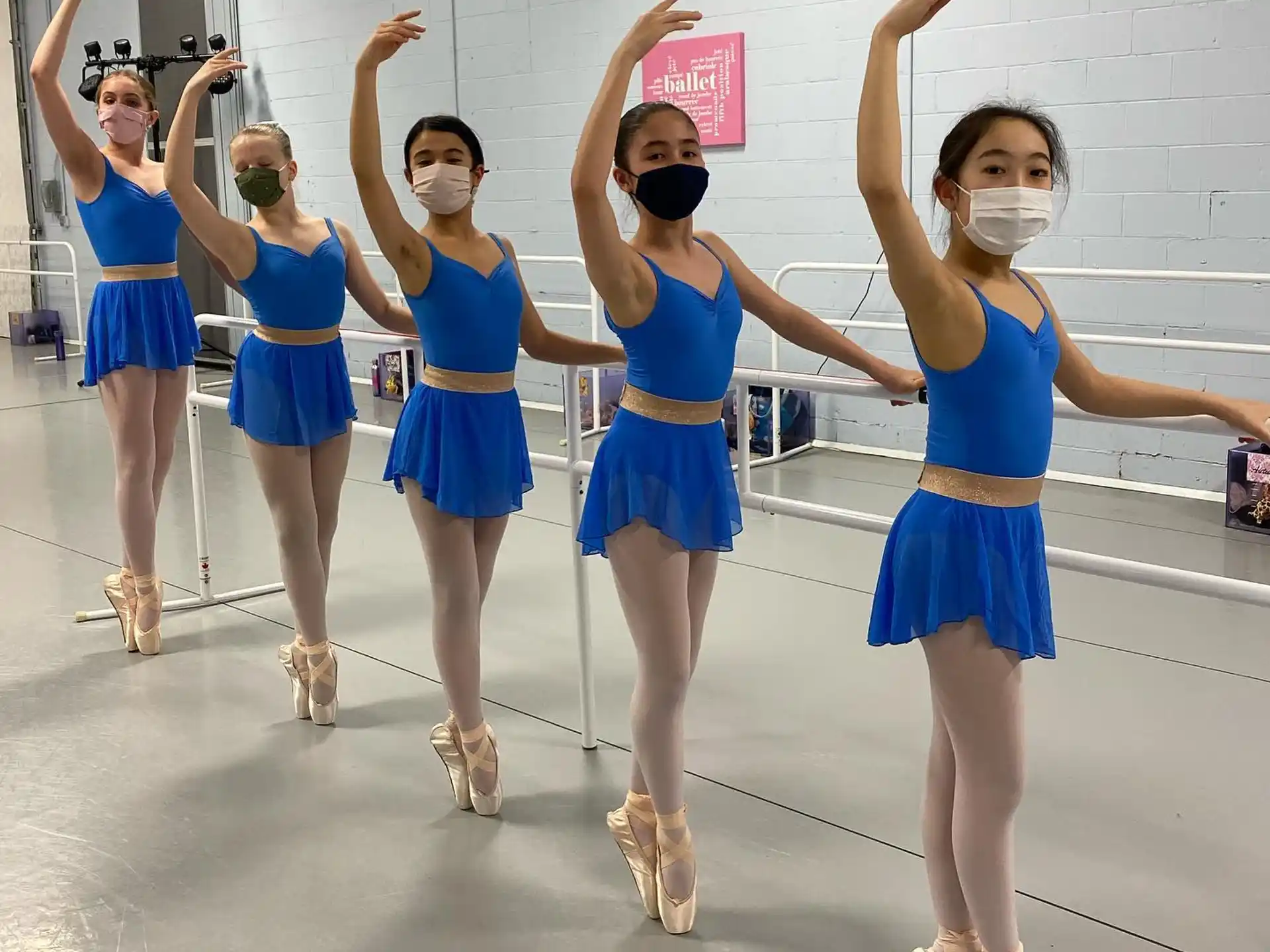 a group of women in blue dresses