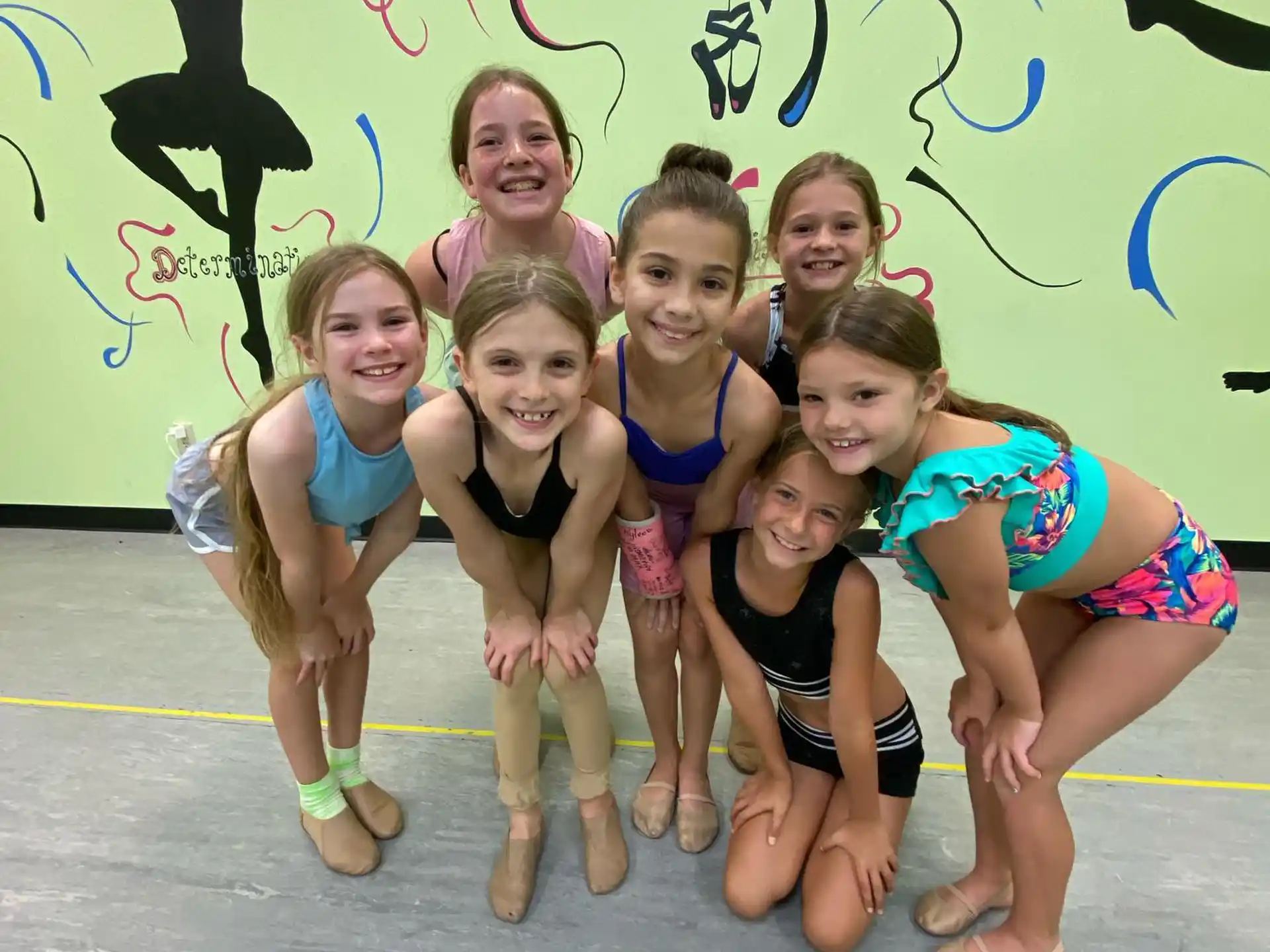 a group of girls in swimsuits posing for a photo