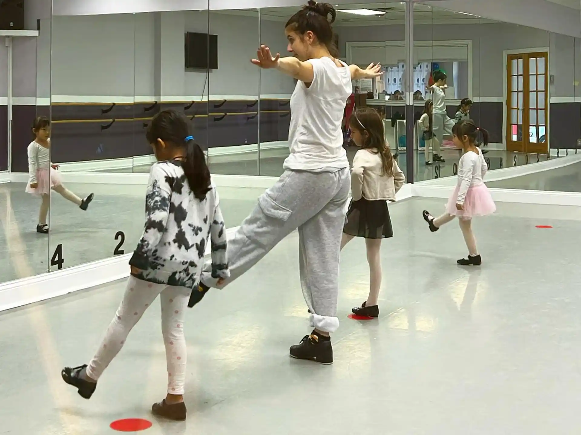 a man and a woman dancing with children in a room