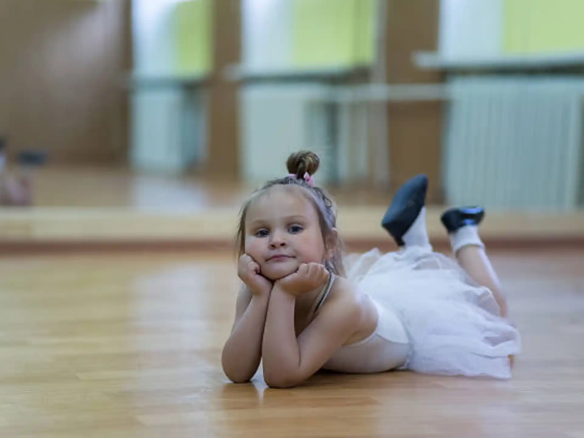a little girl lying on the floor