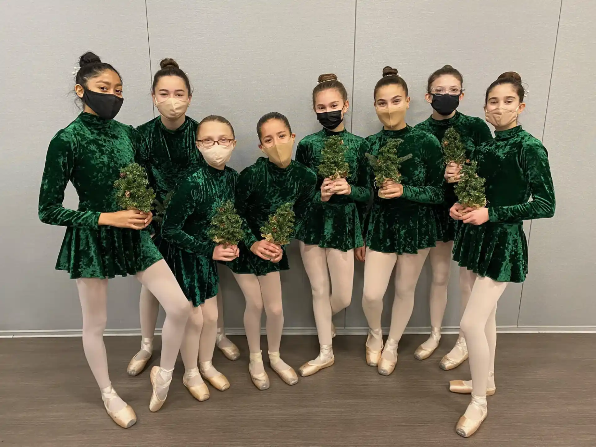 a group of girls in green uniforms