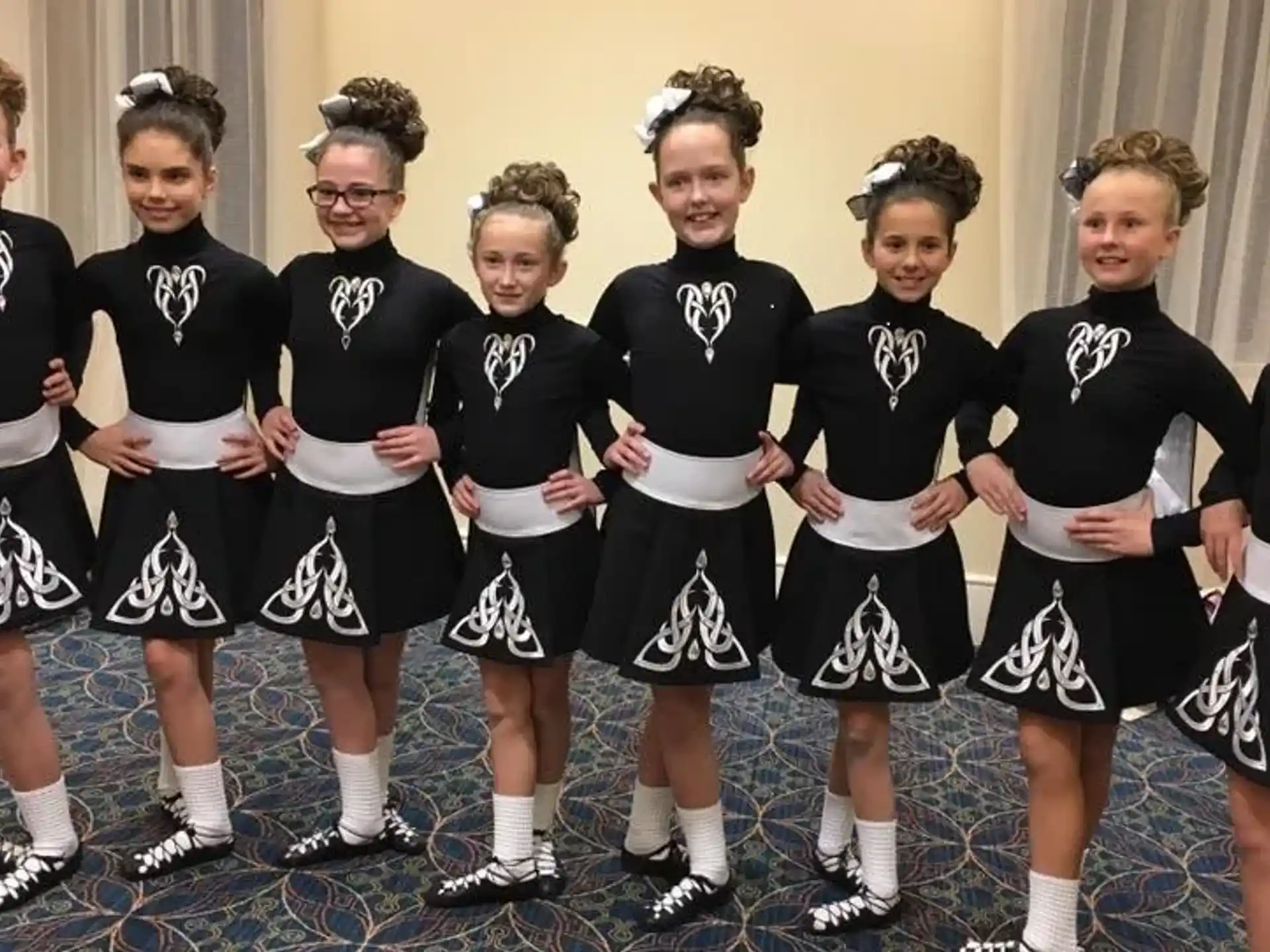 a group of girls in black and white uniforms