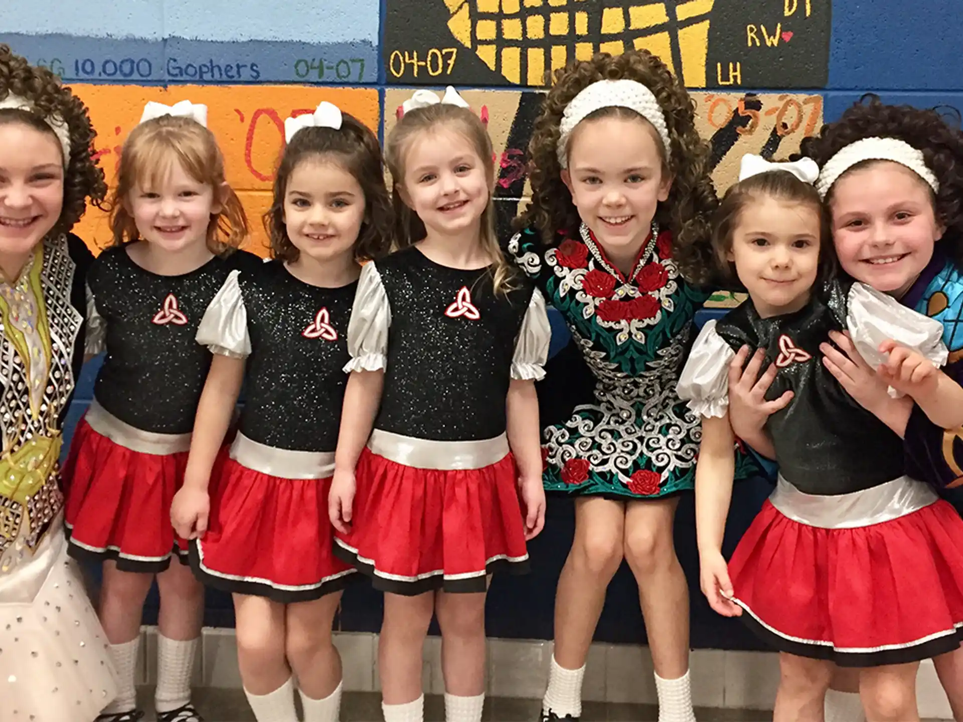 a group of girls in matching outfits