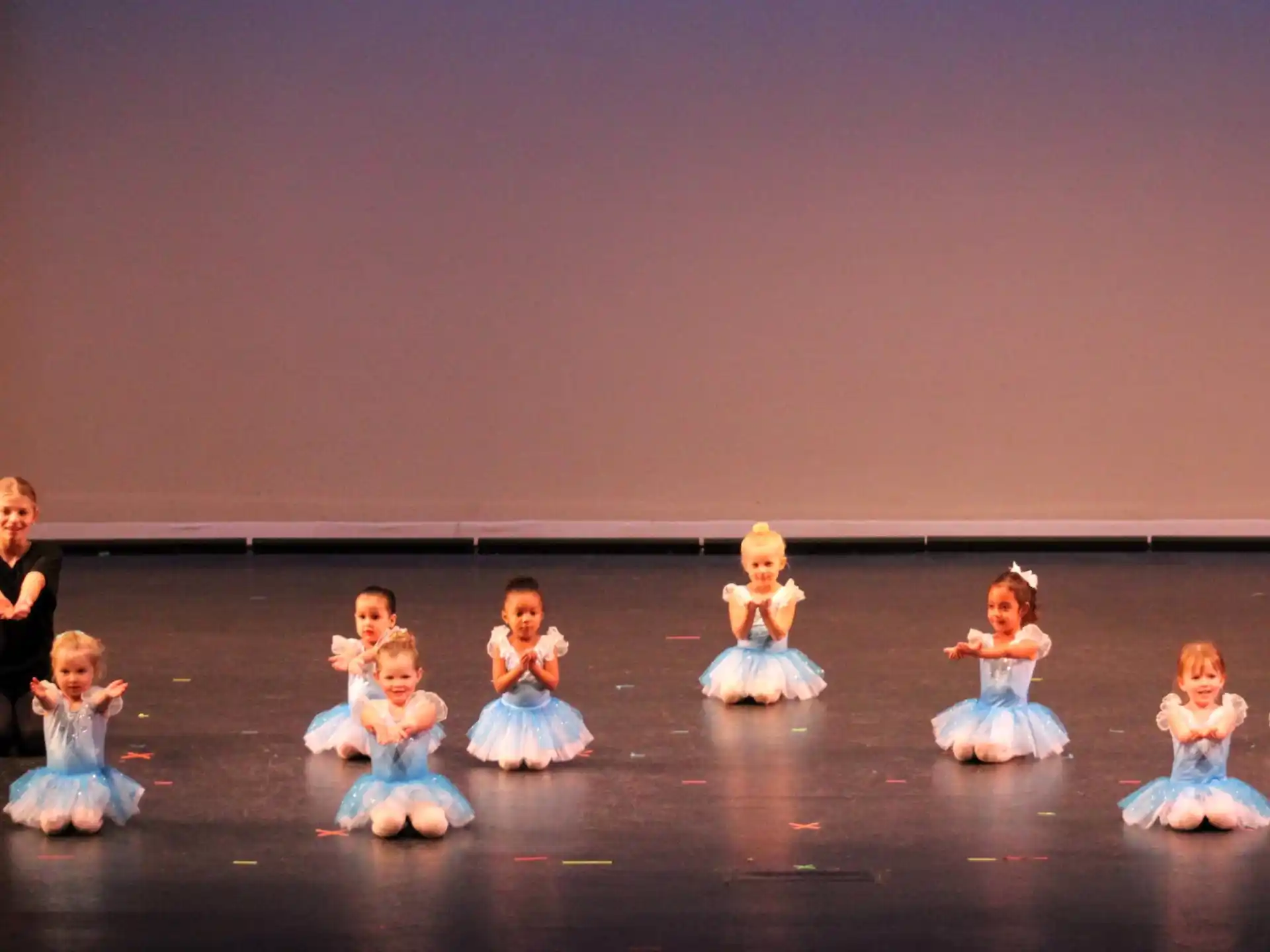 a group of dolls on a stage