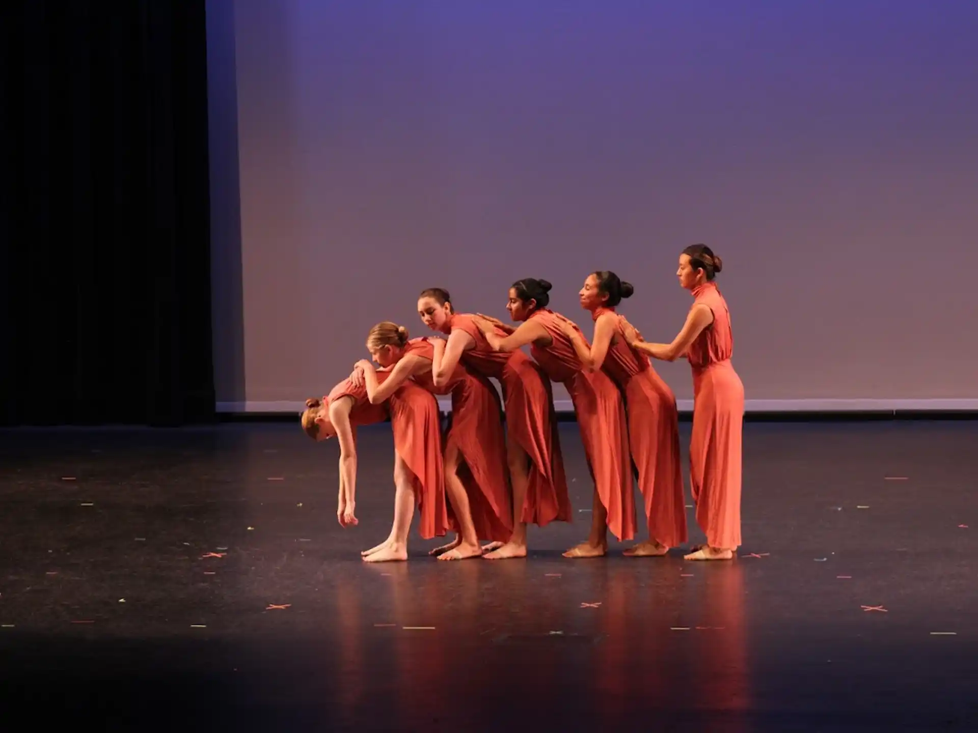 a group of people dancing on a stage