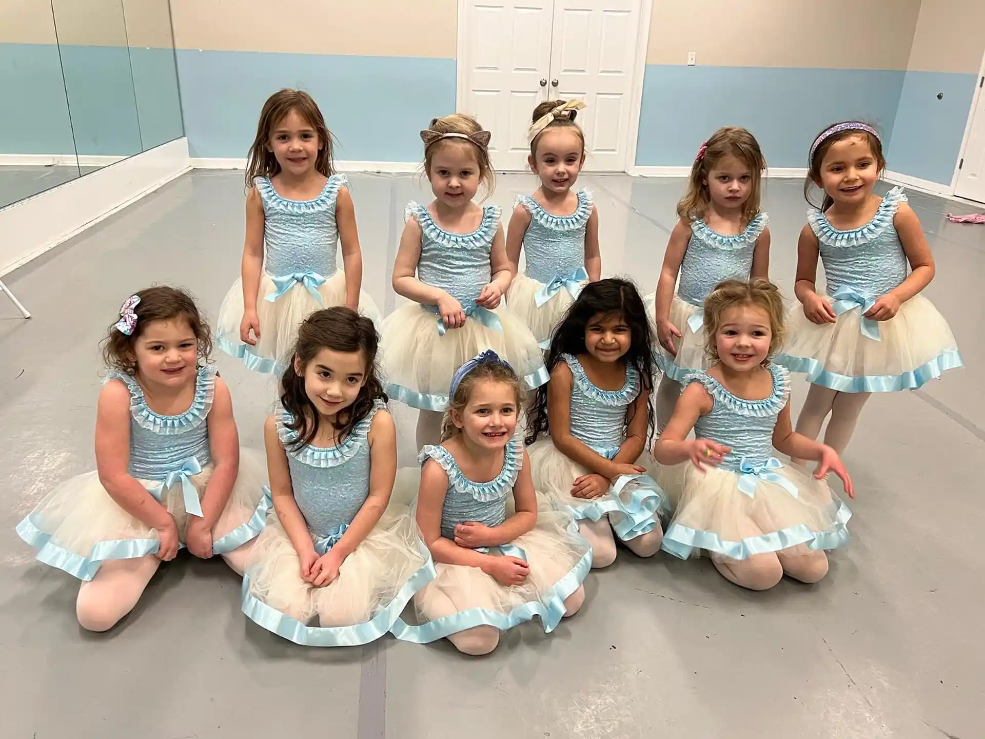 a group of girls in dresses