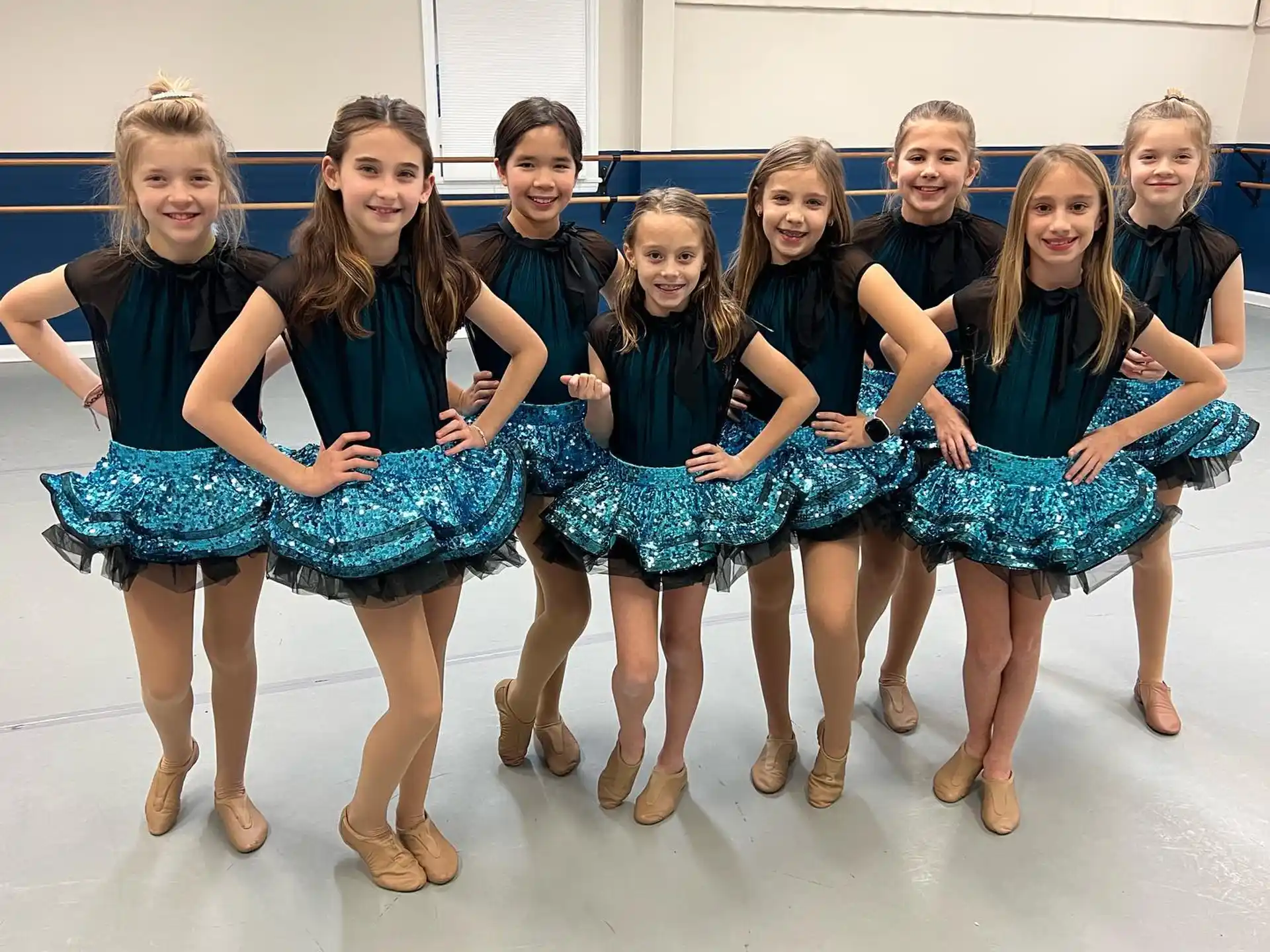 a group of girls in dresses