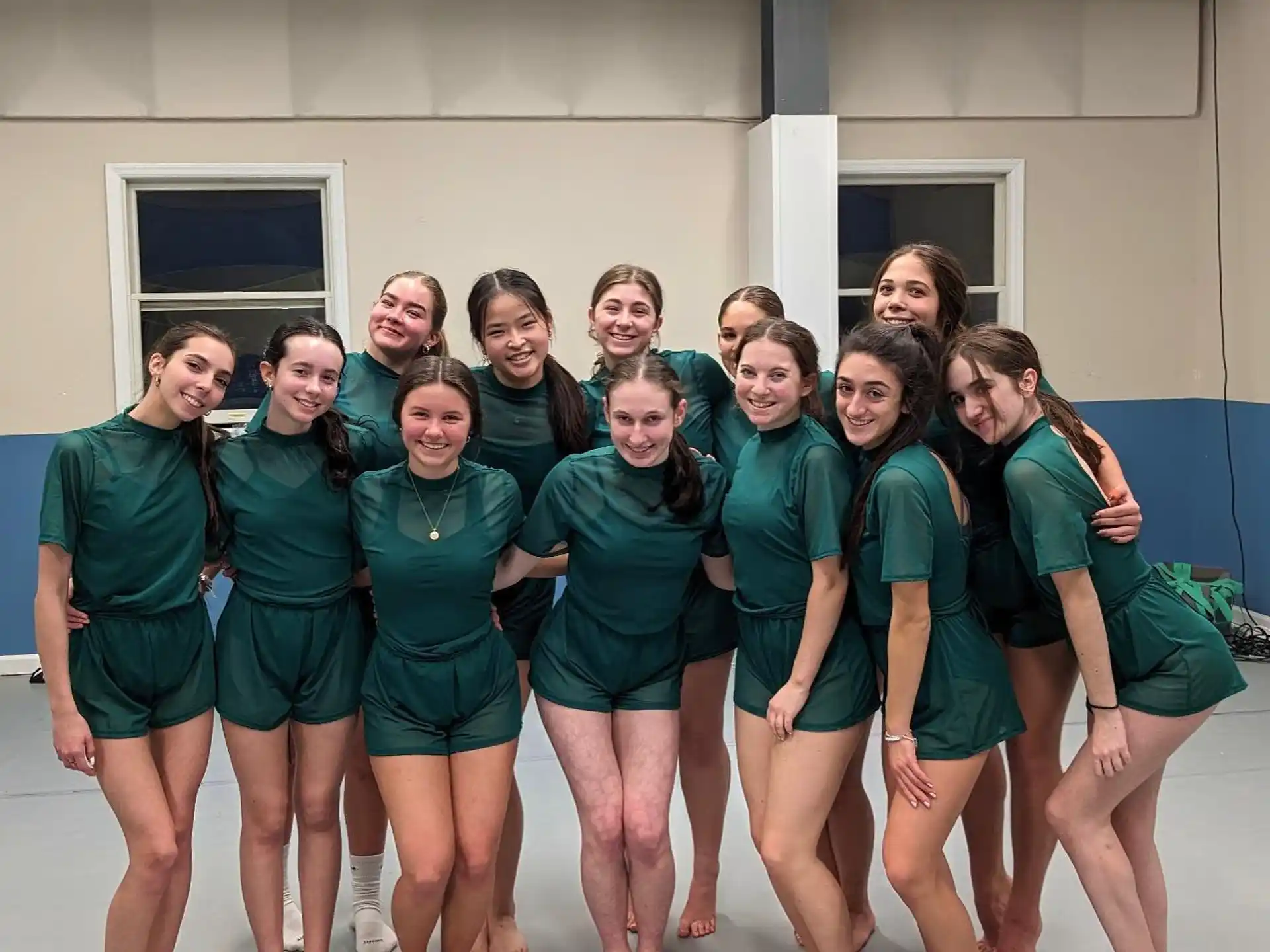 a group of women in green uniforms