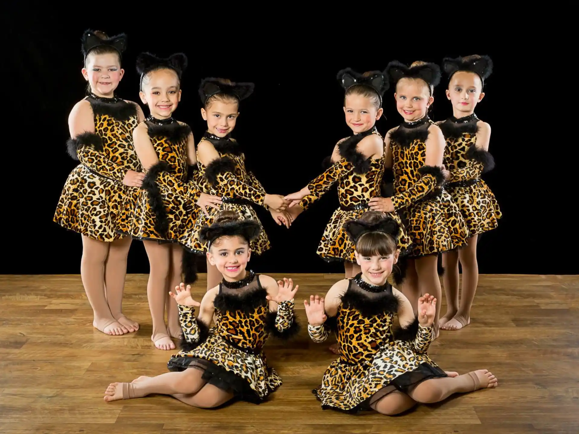 a group of girls in matching dresses
