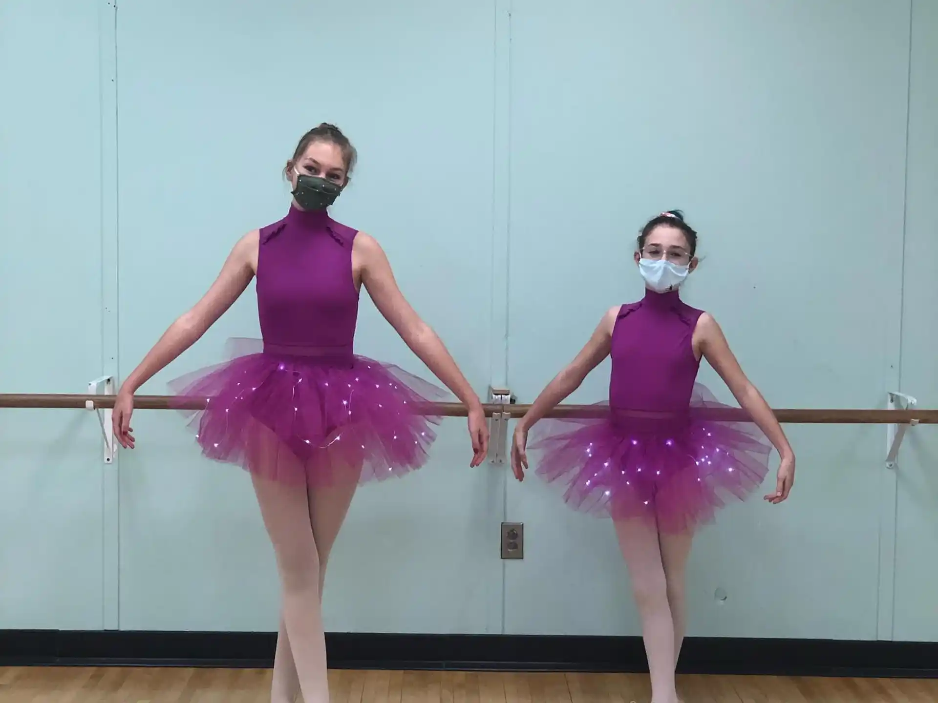 two women in purple dresses