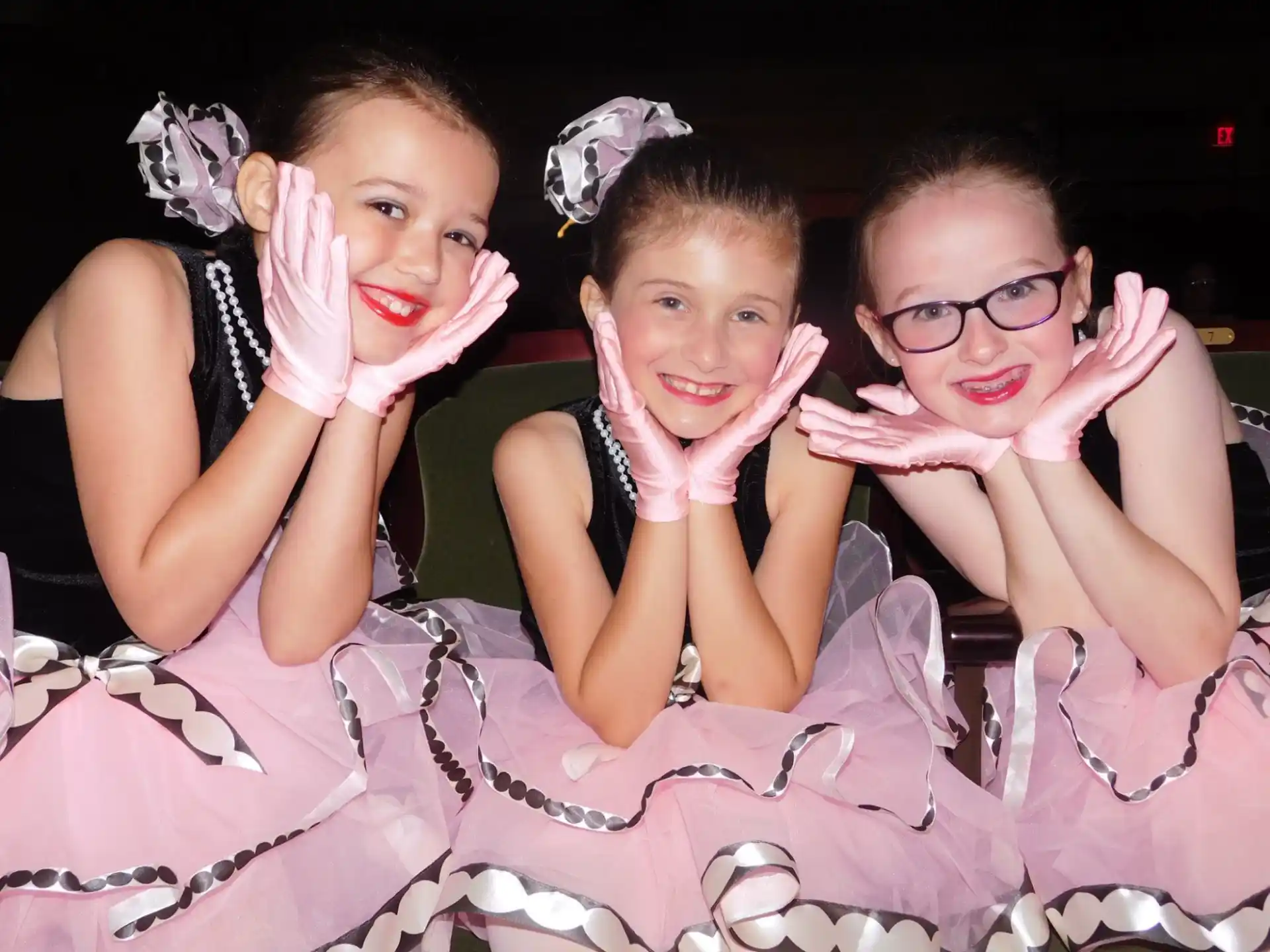 a group of girls in dresses