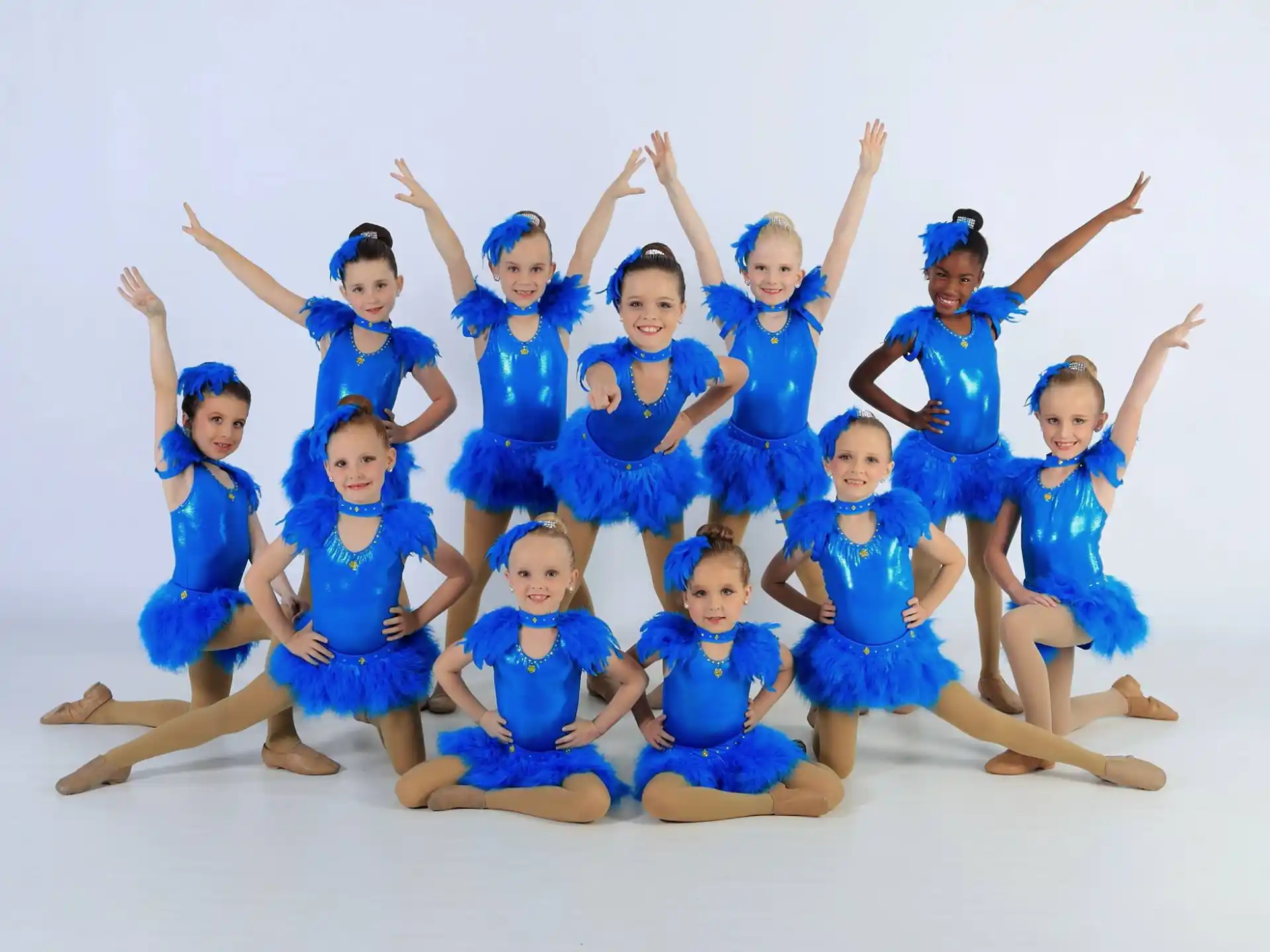 a group of girls in blue dresses