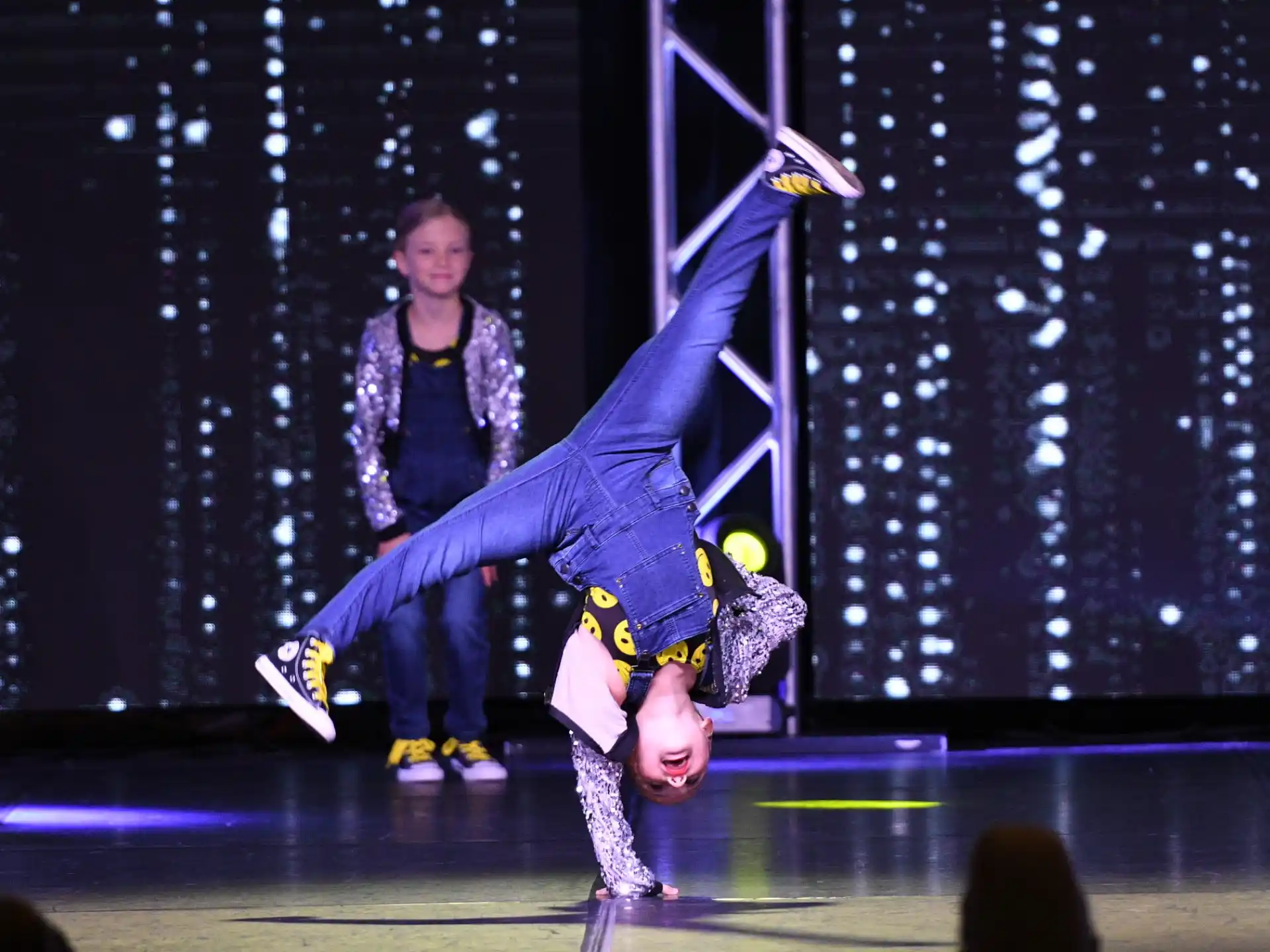 a man and woman dancing on a stage