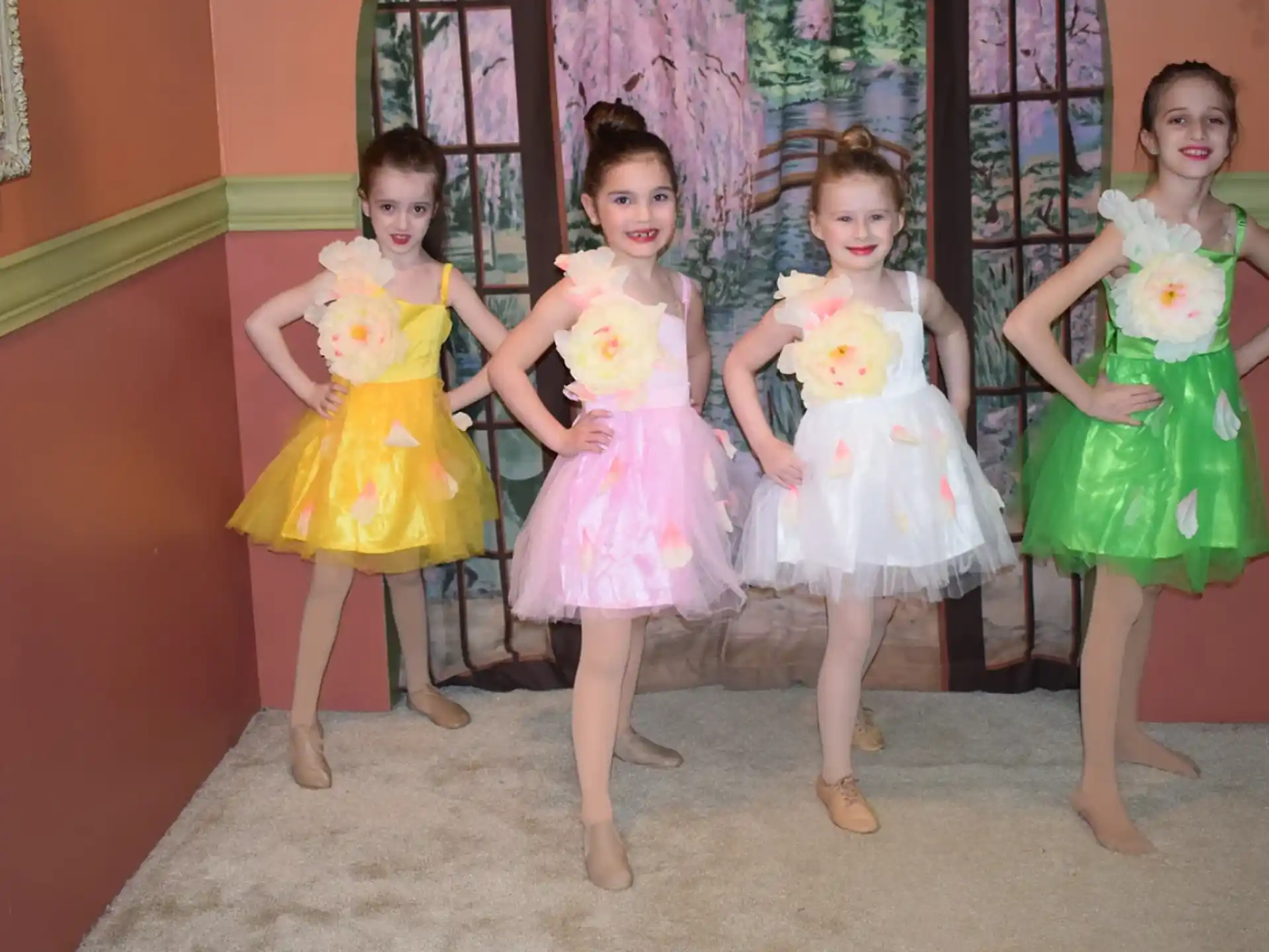 a group of girls in dresses