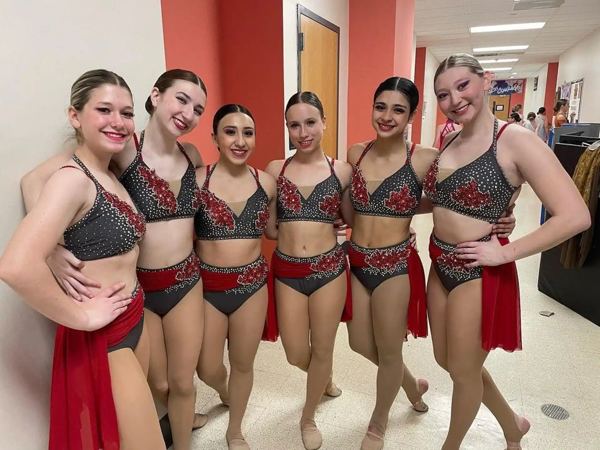 a group of women in red and white dresses