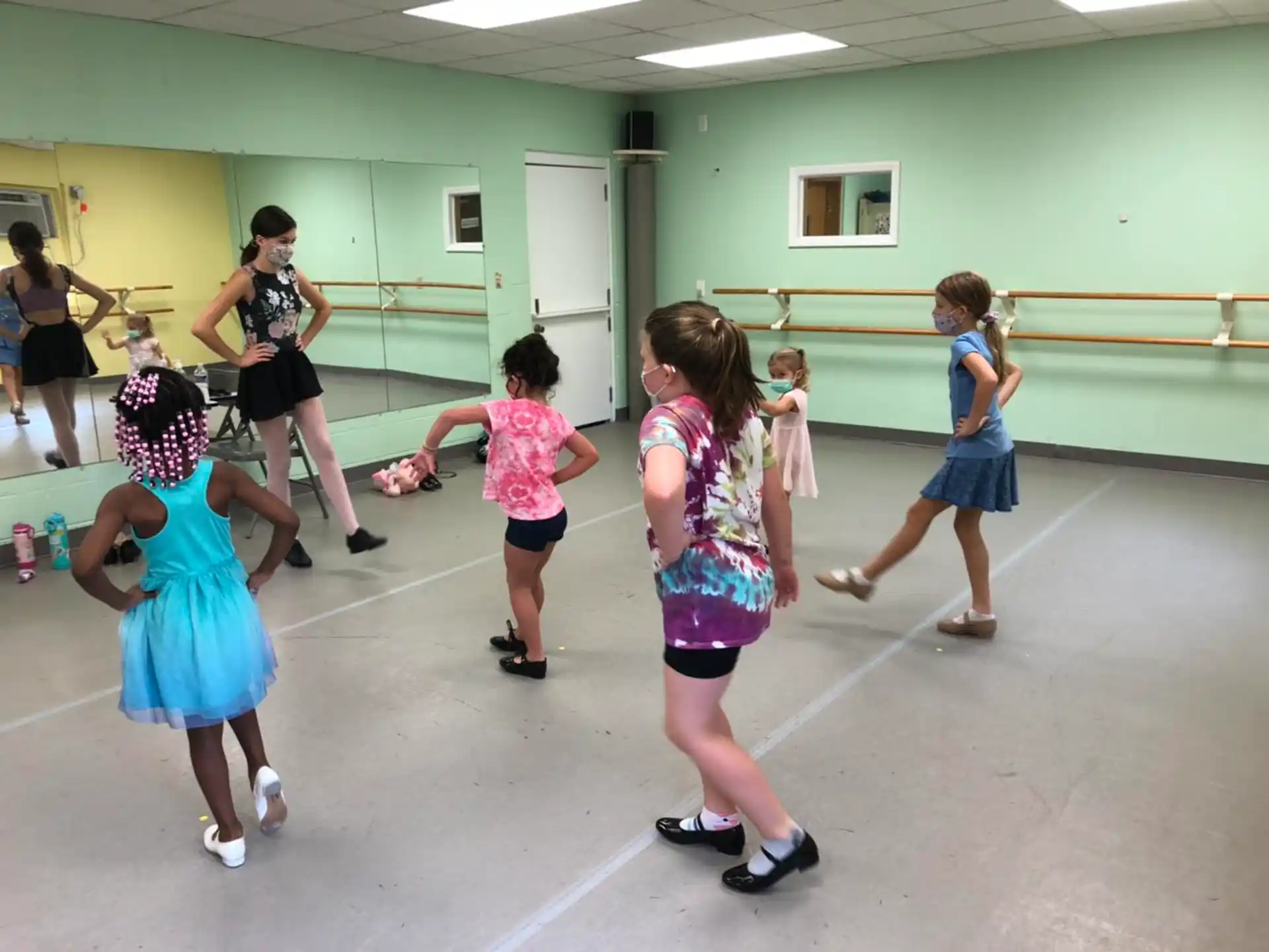 a group of girls dancing in a room