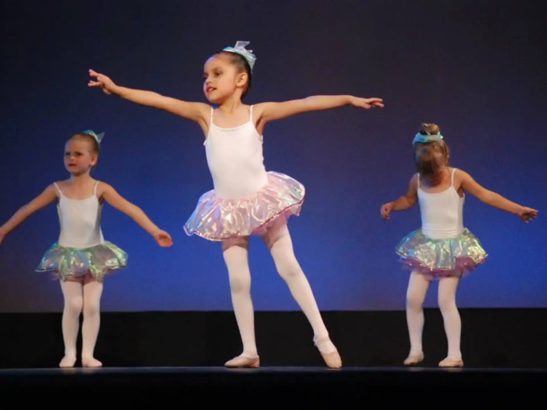 a group of girls dancing on a stage