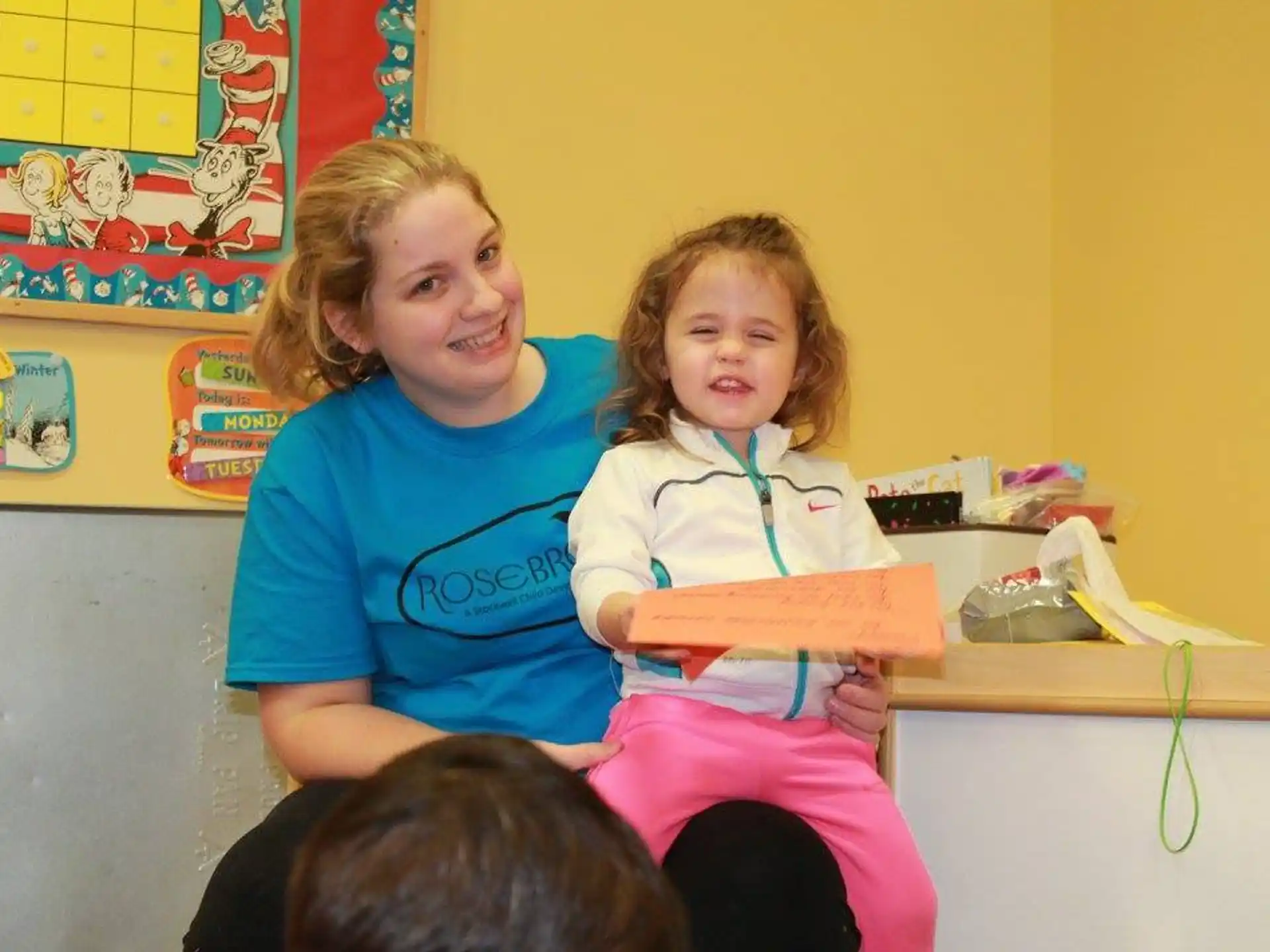 a person and a child sitting on a desk