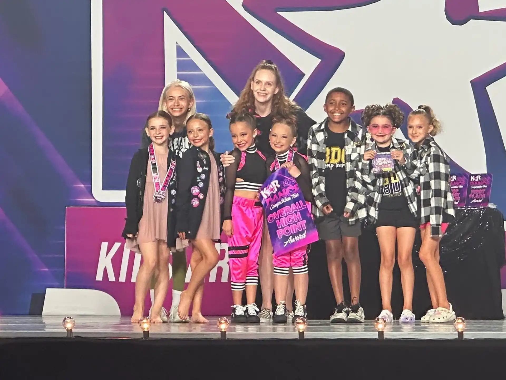 a group of people posing for a photo on a stage