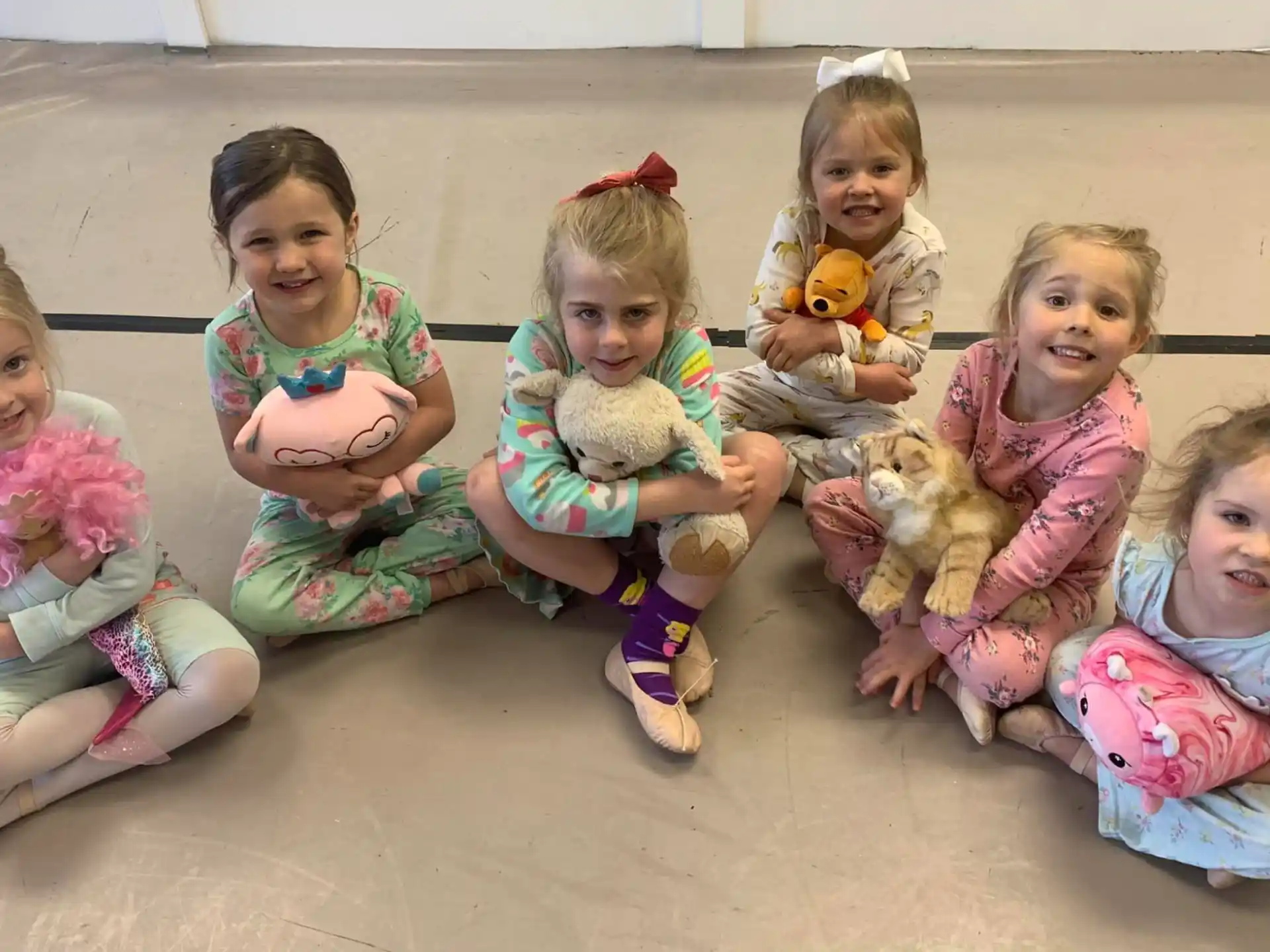 a group of children sitting on the ground
