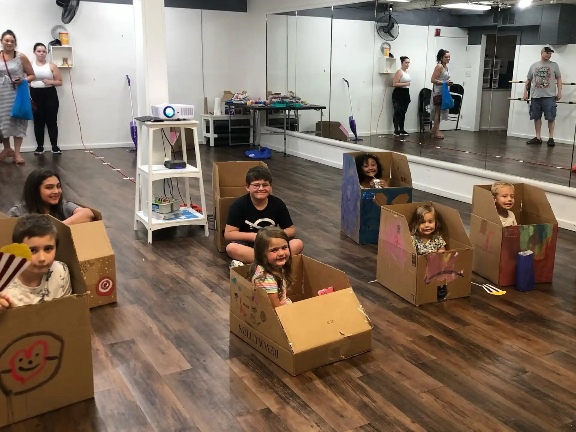 a group of people in a room with boxes