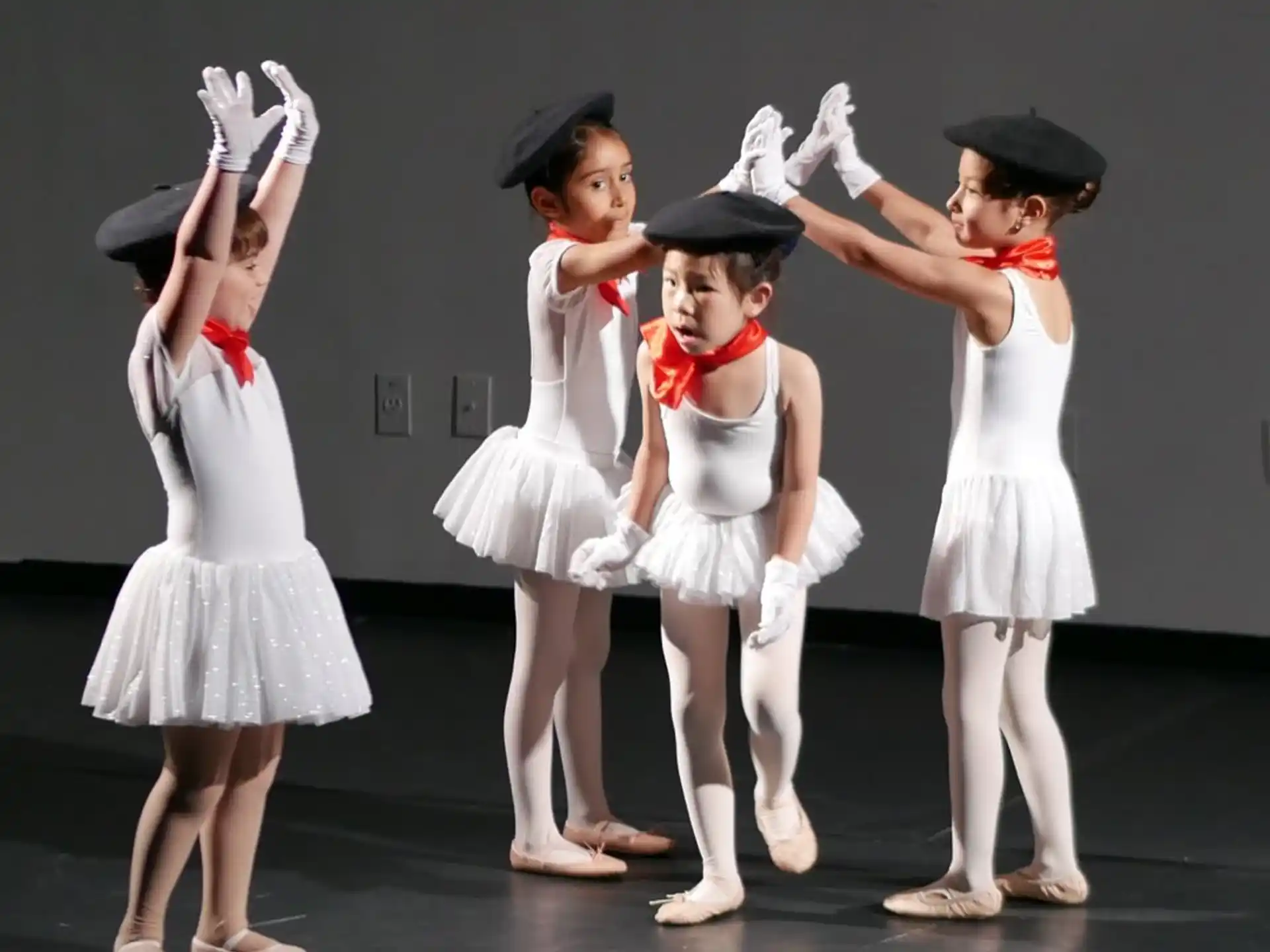 a group of girls wearing white dresses and hats