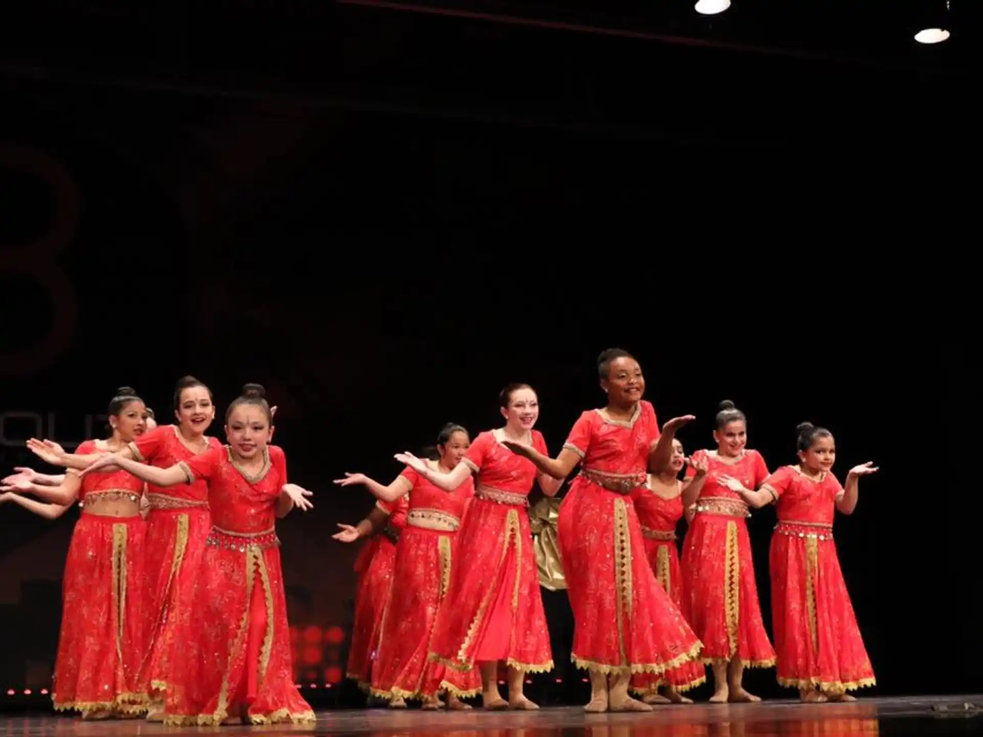 a group of women in red dresses