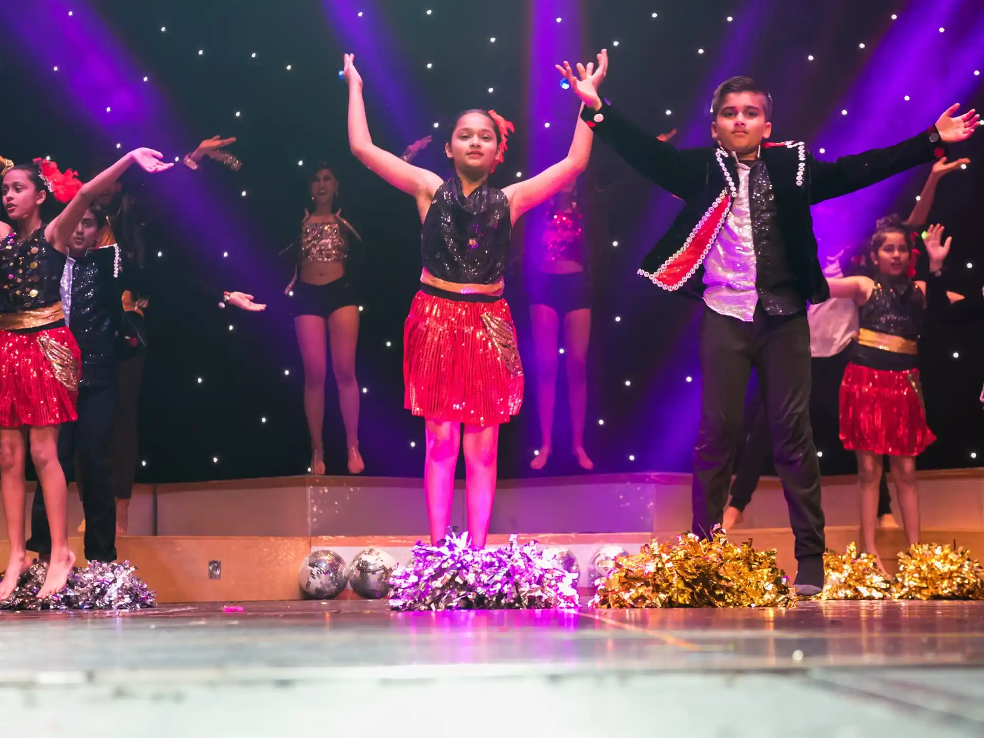 a group of people dancing on a stage