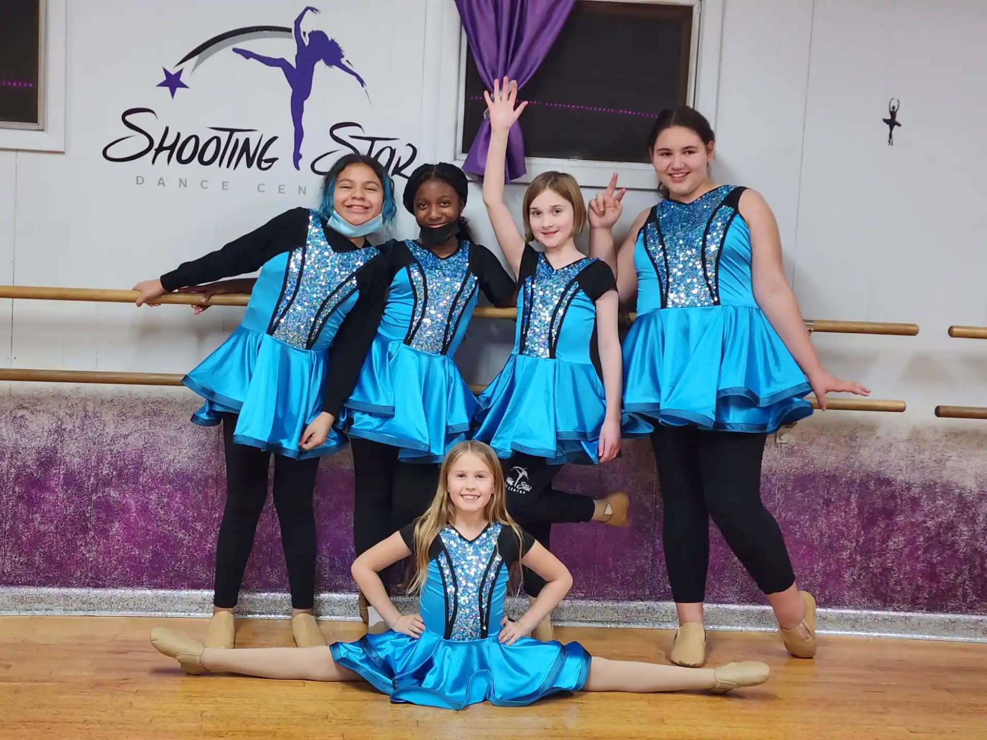 a group of people in blue dresses