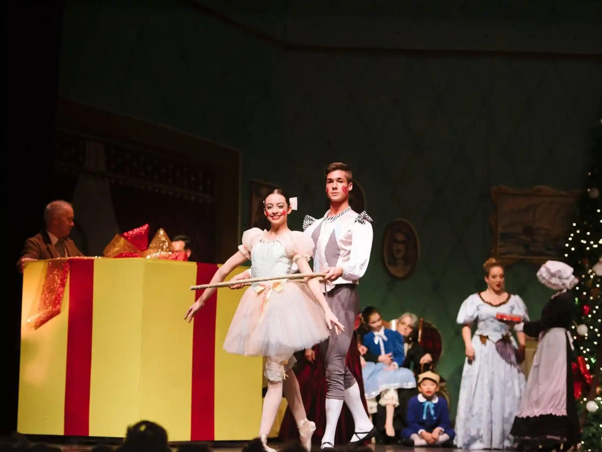 a man and woman dancing on a stage with a crowd watching