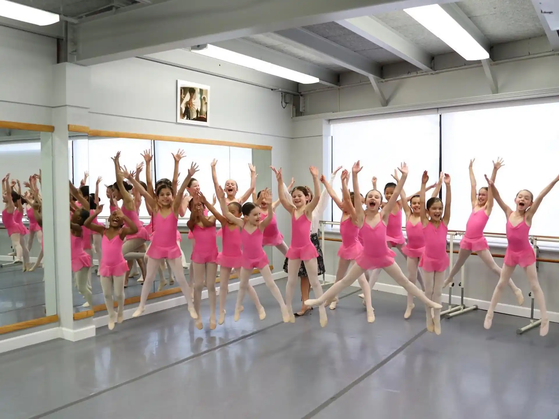 a group of girls in pink dresses
