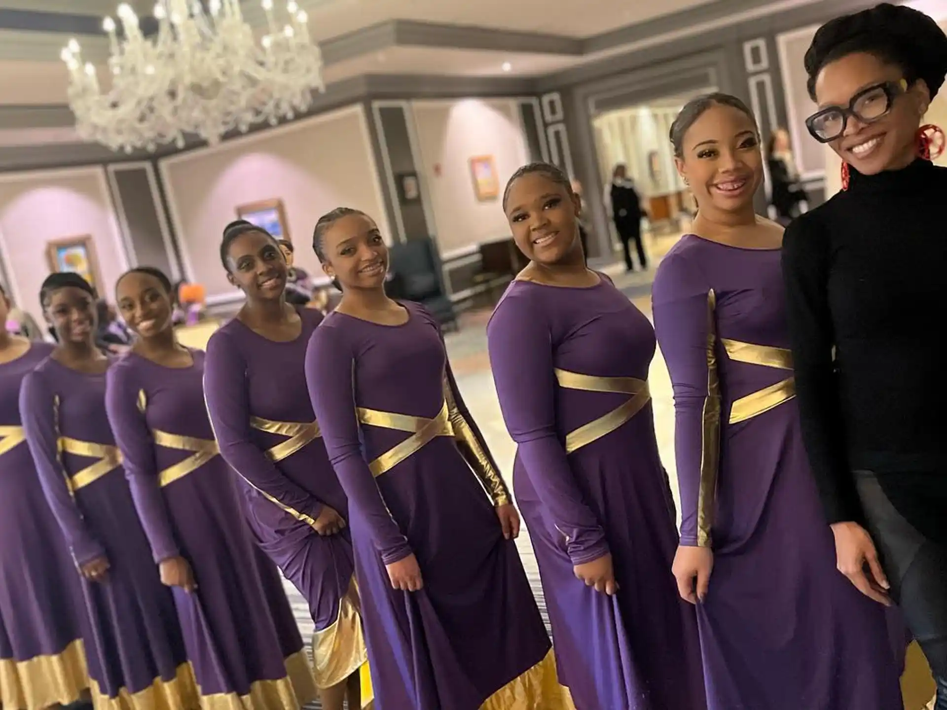 a group of people in purple dresses