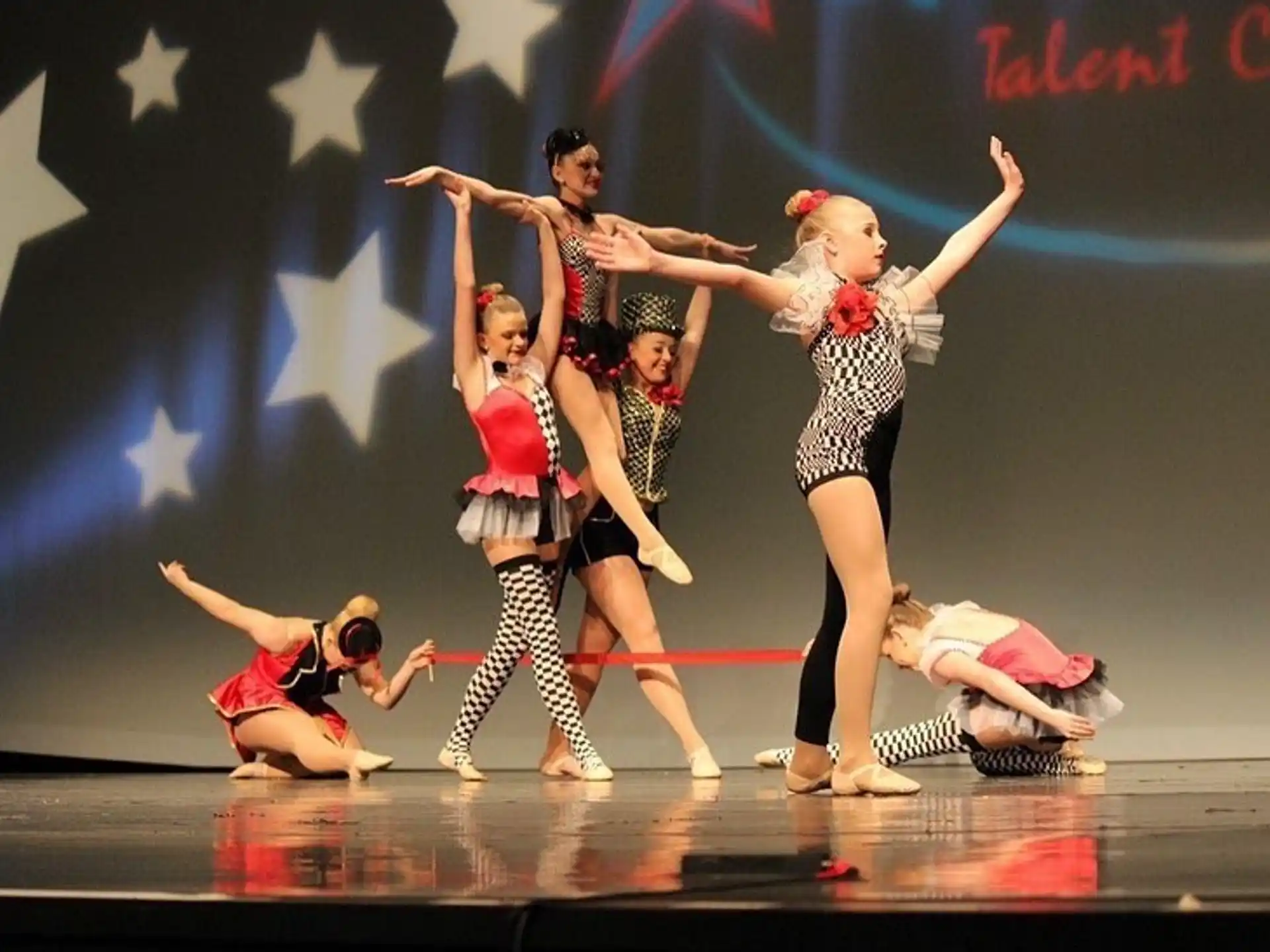 a group of people dancing on a stage