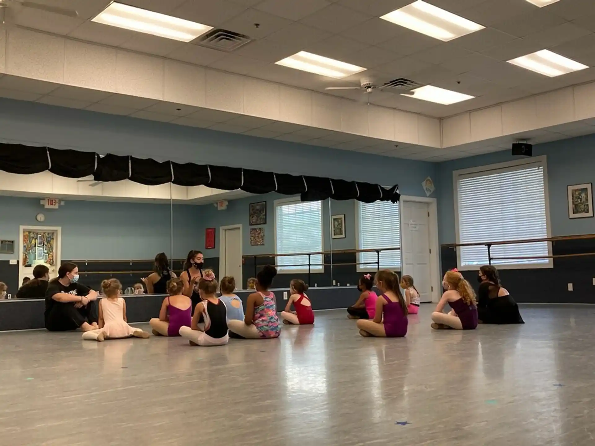 a group of people sitting on the floor in a room