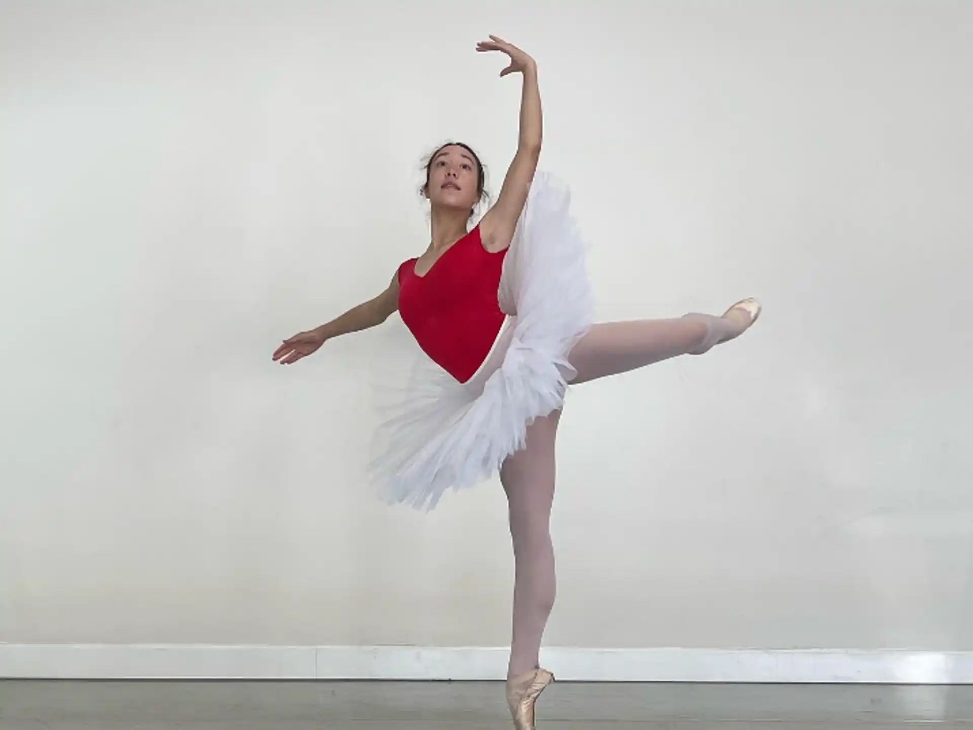a woman in a white dress dancing