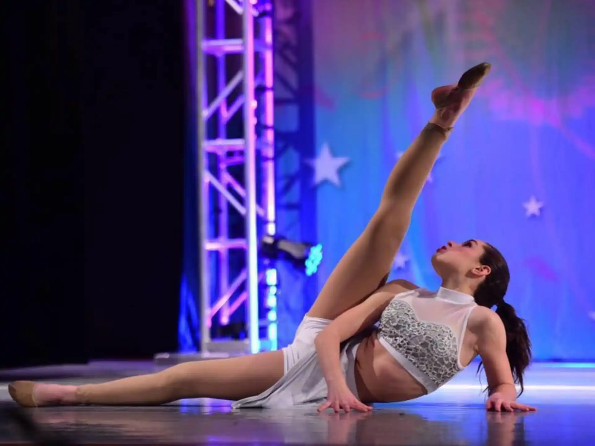 a person doing a yoga pose on a stage