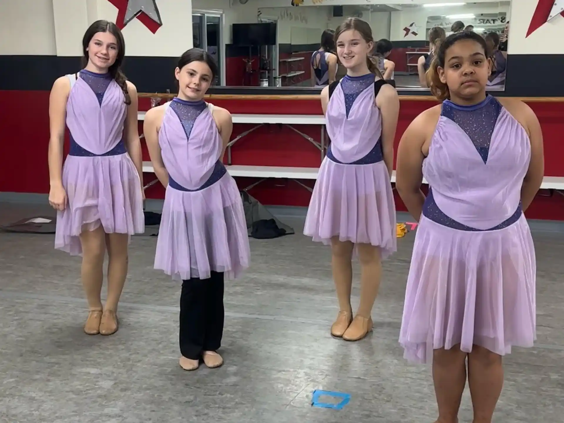 a group of girls in dresses