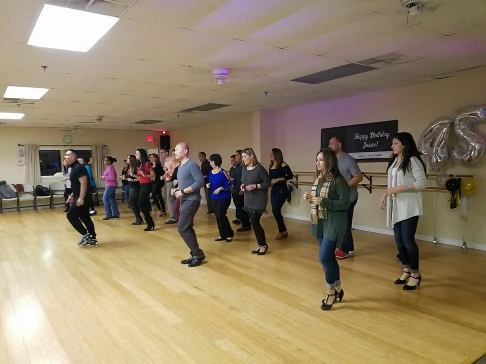 a group of people dancing in a room