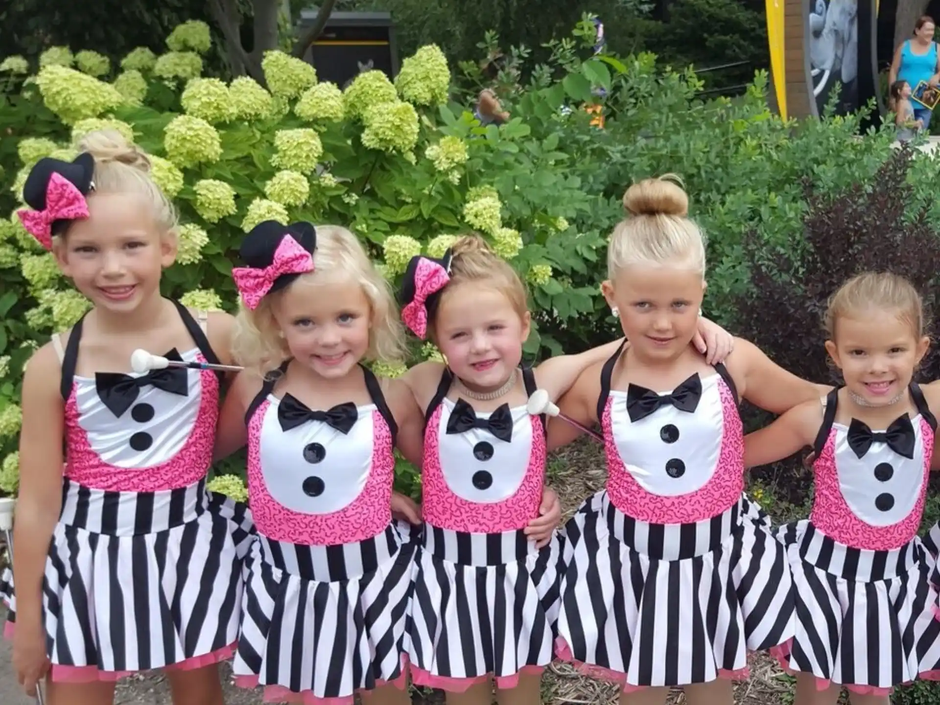 a group of girls in cheerleaders posing for a photo